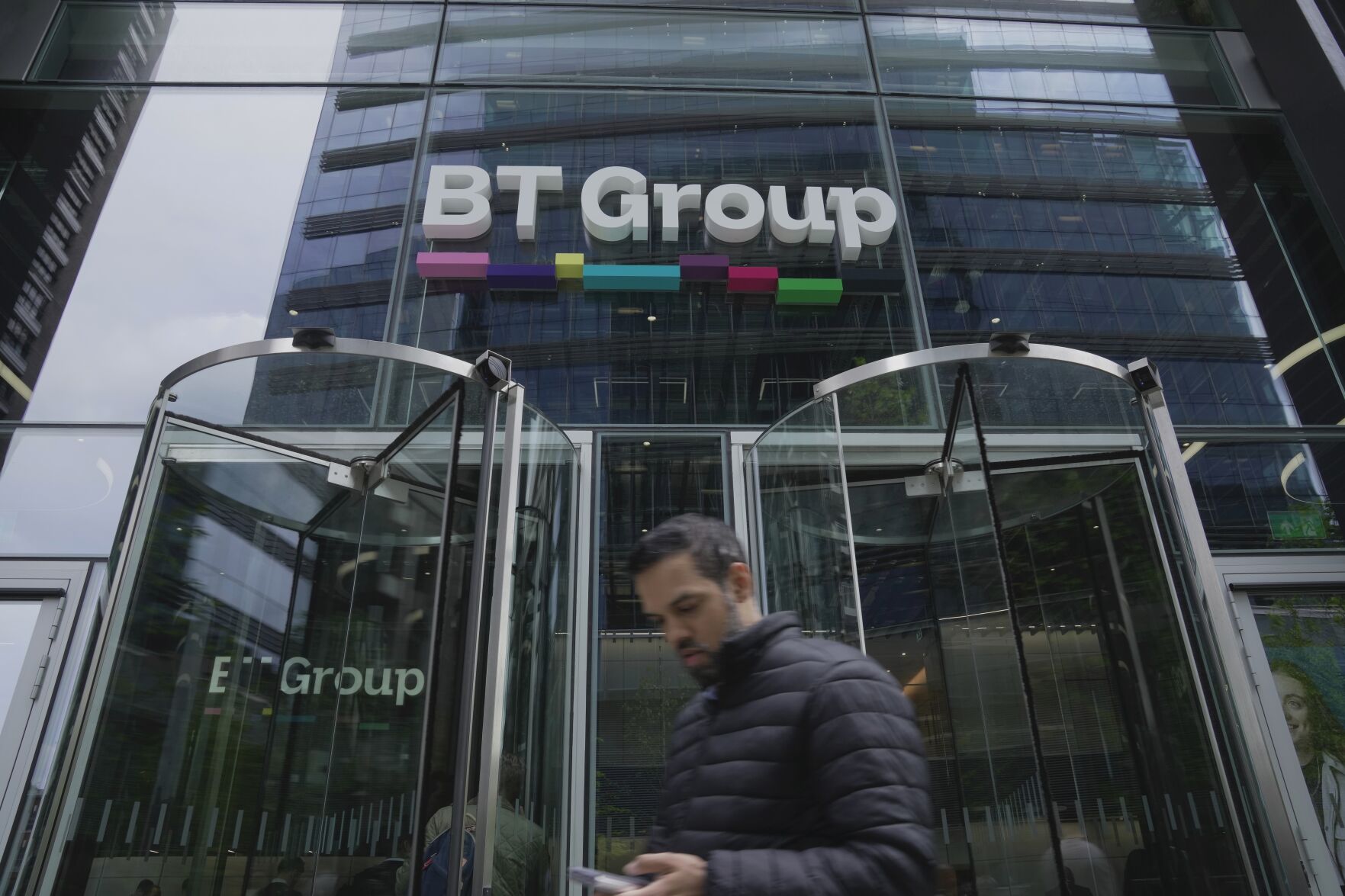 <p>A man walks in front of the BT headquarters, in London, Thursday, May 18, 2023. U.K. telecom company BT Group said Thursday that it plans to shed up to 55,000 jobs by the end of the decade as part of an overhaul aimed at slimming down its workforce to slash costs. (AP Photo/Kin Cheung)</p>   PHOTO CREDIT: Kin Cheung