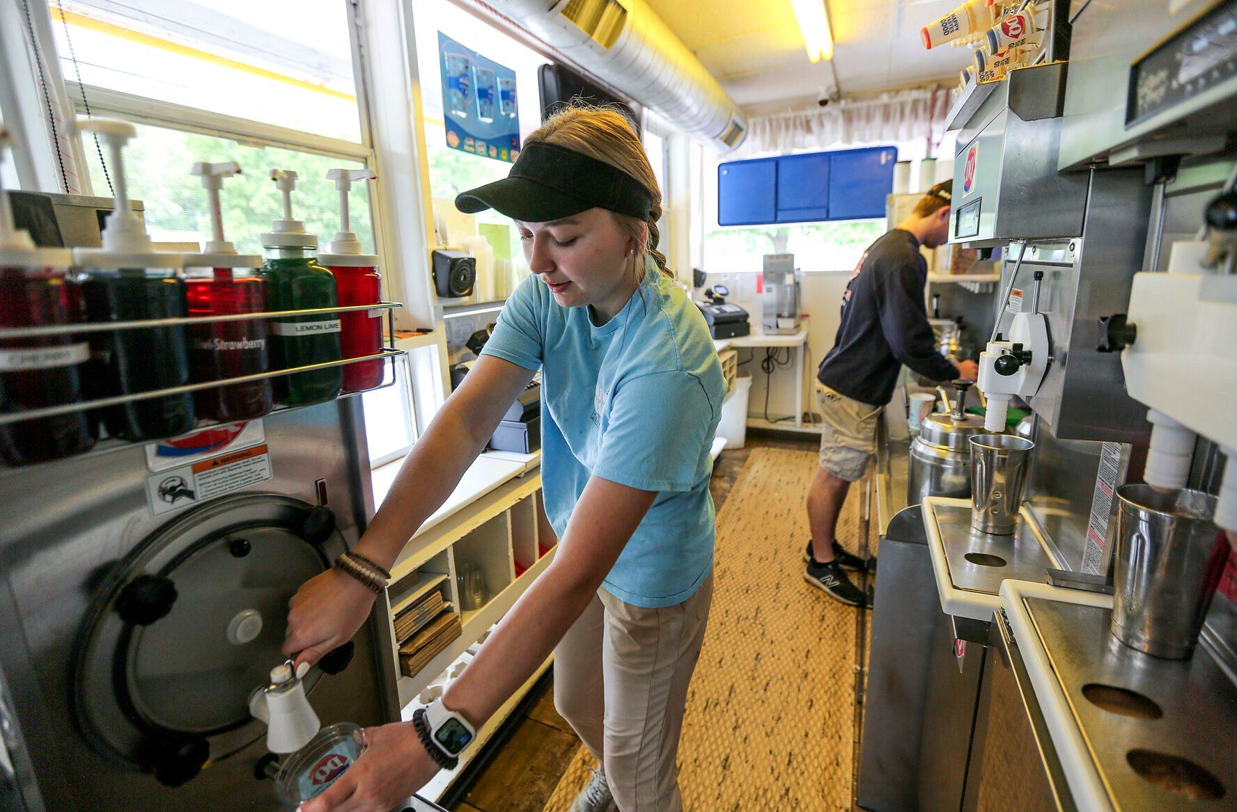 Jaquelyn Hochrein (left) and Johnny Blake serve up treats at the Rhomberg Avenue Dairy Queen in Dubuque.    PHOTO CREDIT: Dave Kettering