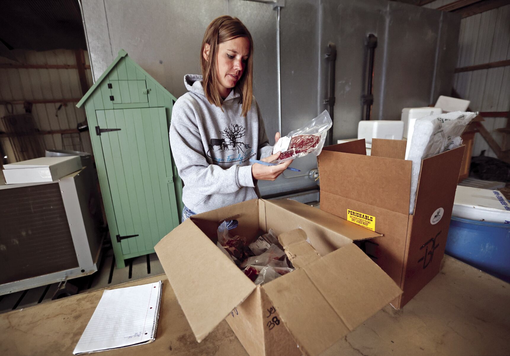 Lillie Beringer fills an order at Beringer Family Farms in Cascade, Iowa.    PHOTO CREDIT: JESSICA REILLY