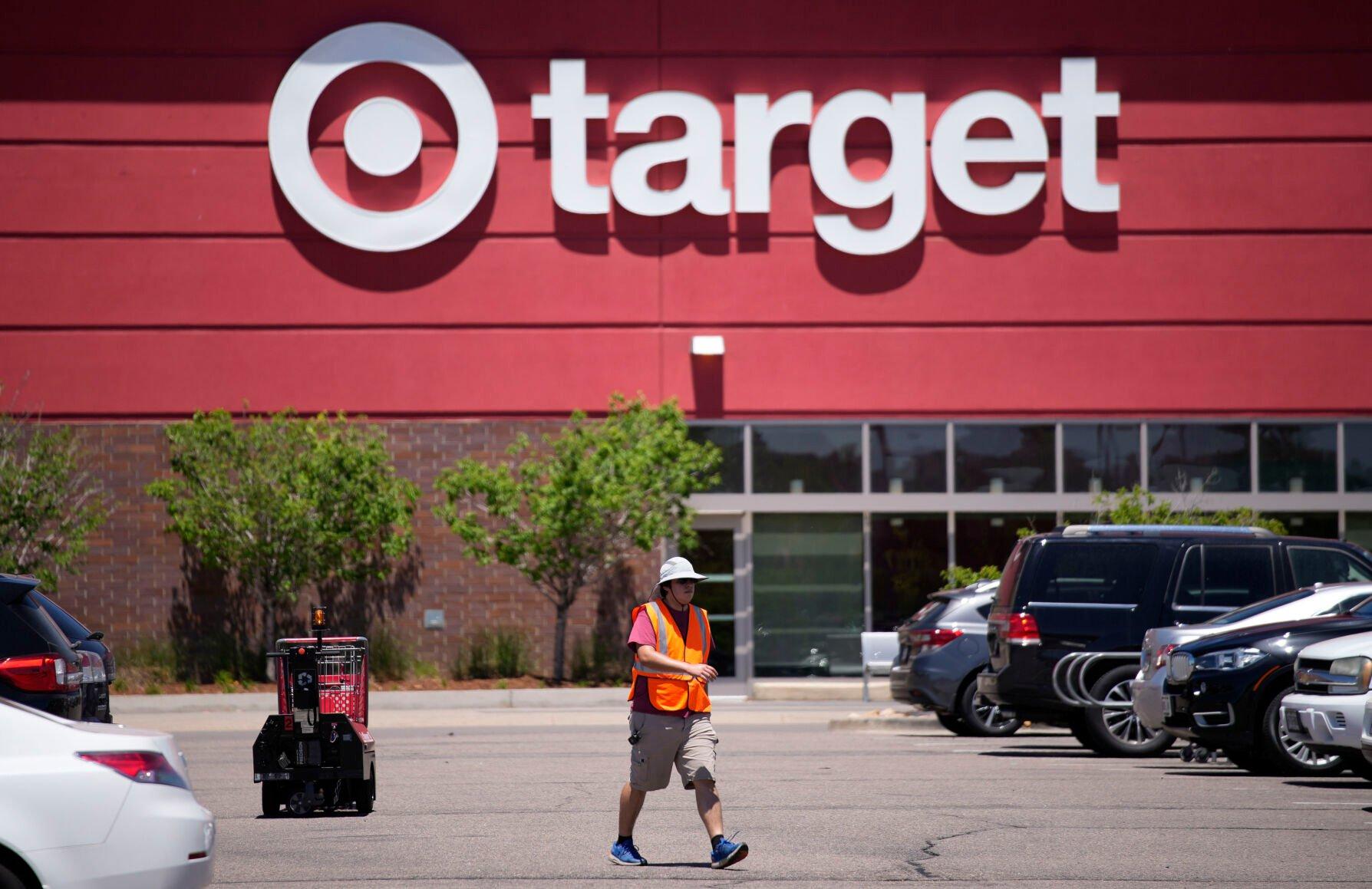 <p>FILE - A worker collects shopping carts in the parking lot of a Target store on June 9, 2021, in Highlands Ranch, Colo. Target is removing certain items from its stores and making other changes to its LGBTQ merchandise nationwide ahead of Pride month, after an intense backlash from some customers including violent confrontations with its workers. (AP Photo/David Zalubowski, File)</p>   PHOTO CREDIT: David Zalubowski 