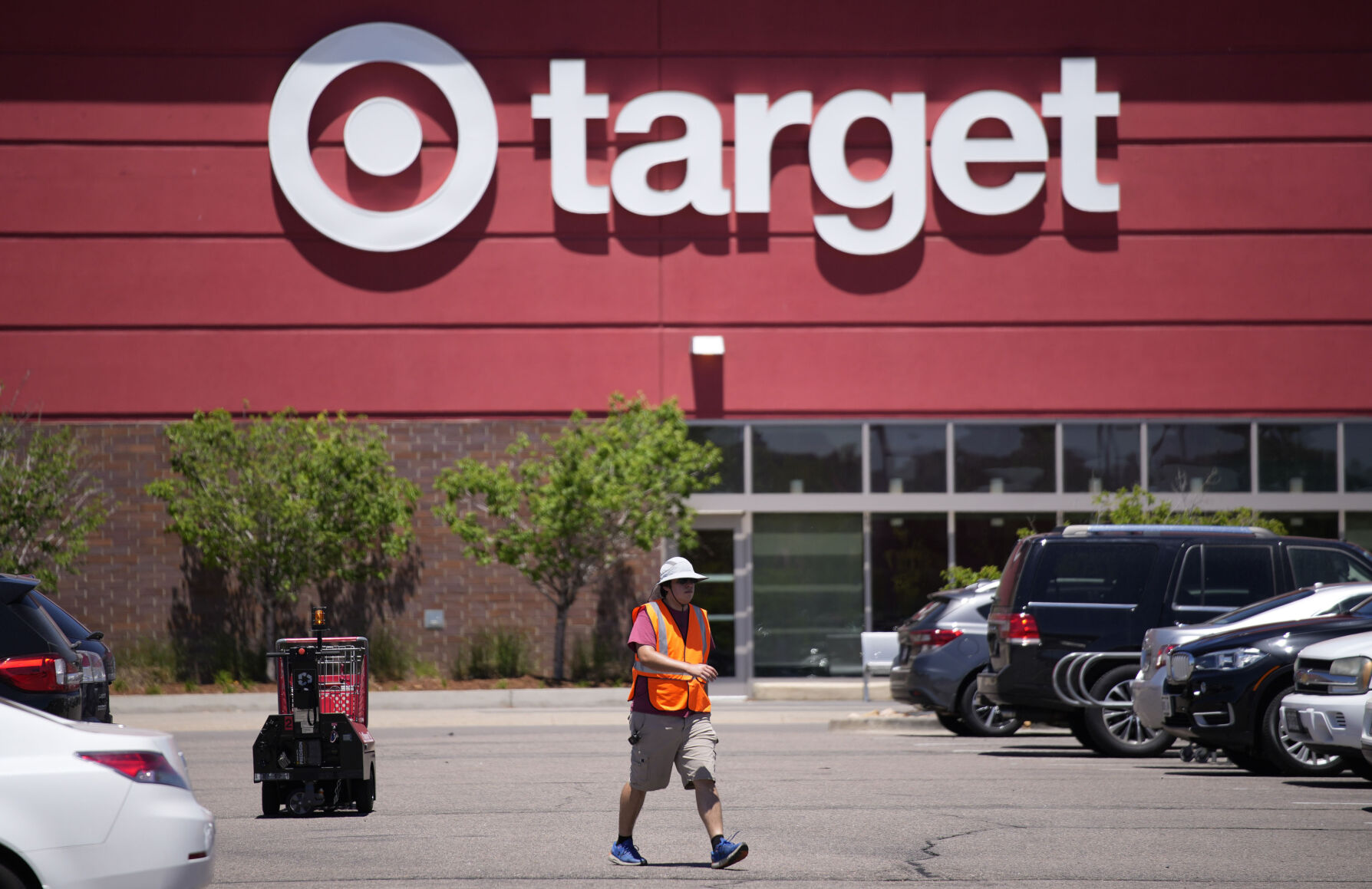 <p>FILE - A worker collects shopping carts in the parking lot of a Target store on June 9, 2021, in Highlands Ranch, Colo. Target is removing certain items from its stores and making other changes to its LGBTQ merchandise nationwide ahead of Pride month, after an intense backlash from some customers including violent confrontations with its workers. (AP Photo/David Zalubowski, File)</p>   PHOTO CREDIT: David Zalubowski 