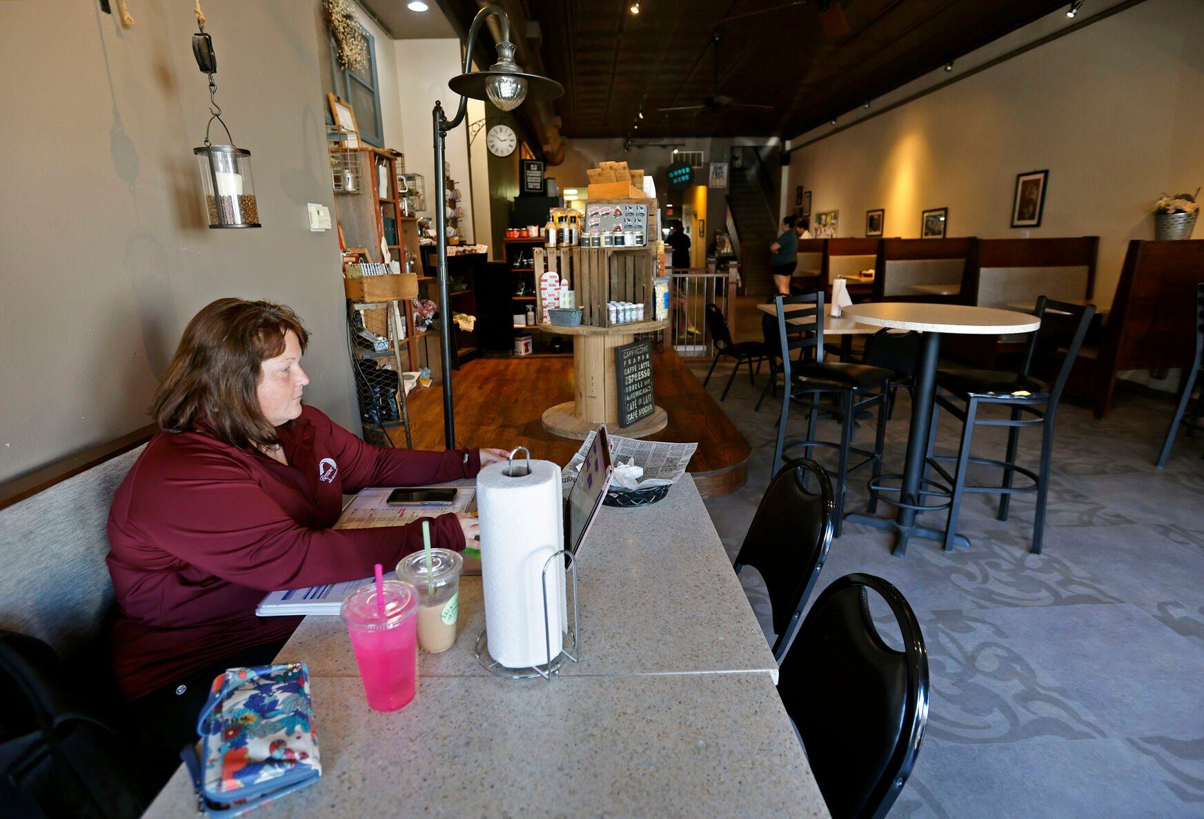 Shana Willenbring, of Dyersville, Iowa, works on her laptop at Brew & Brew in Dyersville on Friday, May 26, 2023.    PHOTO CREDIT: JESSICA REILLY