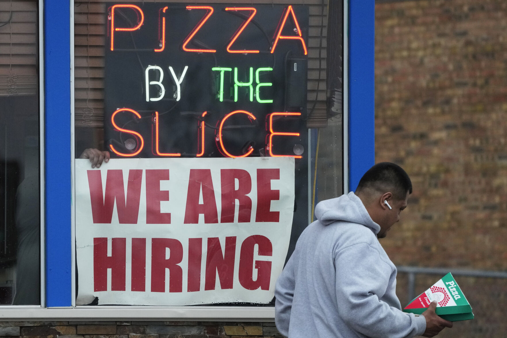 <p>FILE - A hiring sign is displayed at a restaurant in Prospect Heights, Ill., on April 4, 2023. The hot jobs market has been defying a weakening economy and confounding the Federal Reserve for months, but now shows signs of cooling. The latest set of employment data from the government shows that job openings fell in March to their lowest level since April 2021. Layoffs rose to 1.8 million, their highest level since December 2020. (AP Photo/Nam Y. Huh, File)</p>   PHOTO CREDIT: Nam Y. Huh