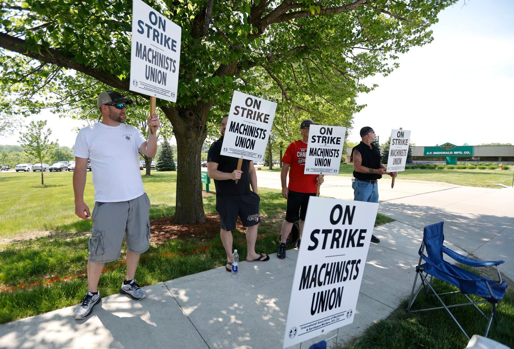 Jeff Fellenzer (from left), Ryan Kirby, Chuck Hoppman and Jason Horstman, all employees at A.Y. McDonald Mfg. Co., picket outside the facility on Chavenelle Road in Dubuque on Thursday, June 1, 2023.    PHOTO CREDIT: JESSICA REILLY