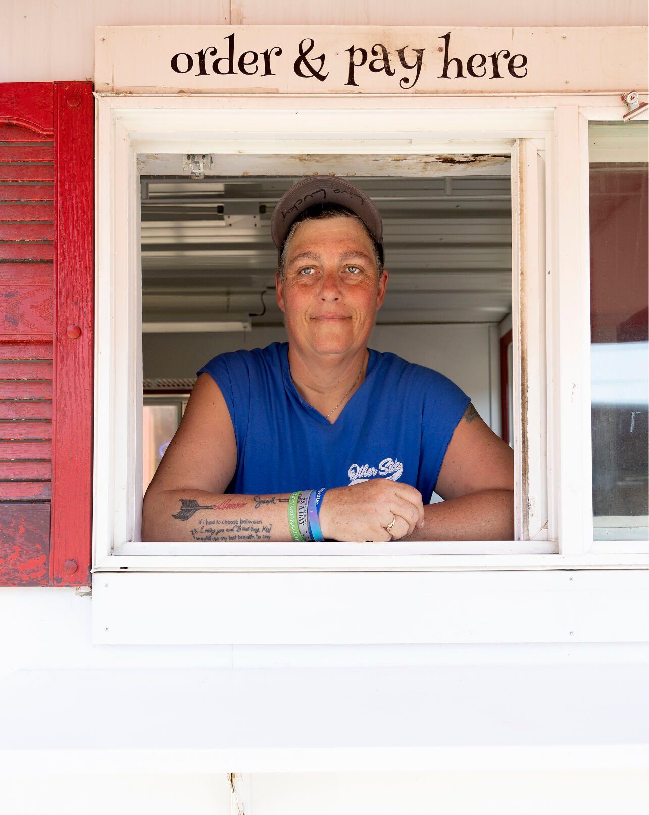 Owner Michelle Mulgrew looks out of her food truck, Other Side On The Go, while at the Dubuque Farmers Market on Saturday, June 3, 2023.    PHOTO CREDIT: Stephen Gassman