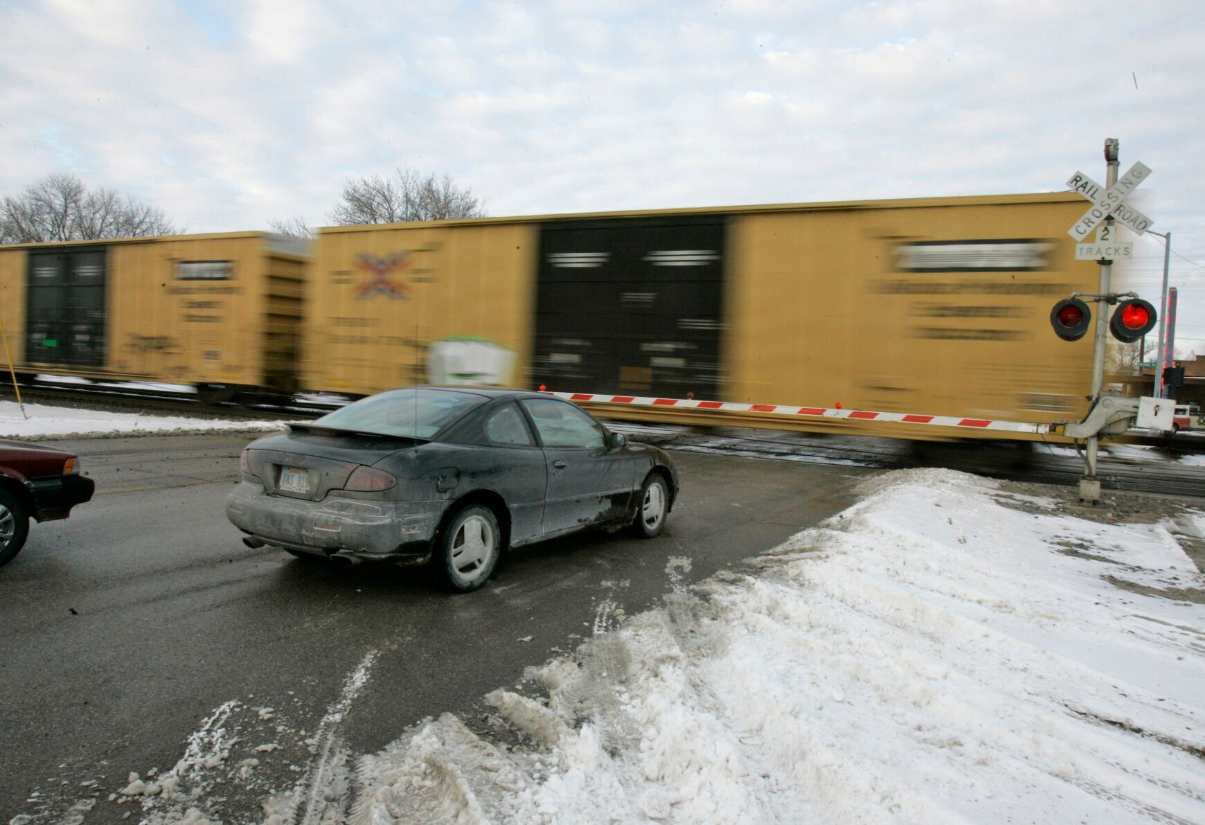 <p>FILE - Cars wait for a train to pass, in Valley, Neb., Wednesday, Jan. 17, 2007. With the rail industry relying on longer and longer trains to cut costs, the Biden administration is handing out $570 million in grants to help eliminate railroad crossings in 32 states. The grants announced Monday, June 5, 2023 will help eliminate more than three dozen crossings that delay traffic and sometimes keep first responders from where help is desperately needed. (AP Photo/Nati Harnik, File)</p>   PHOTO CREDIT: Nati Harnik 