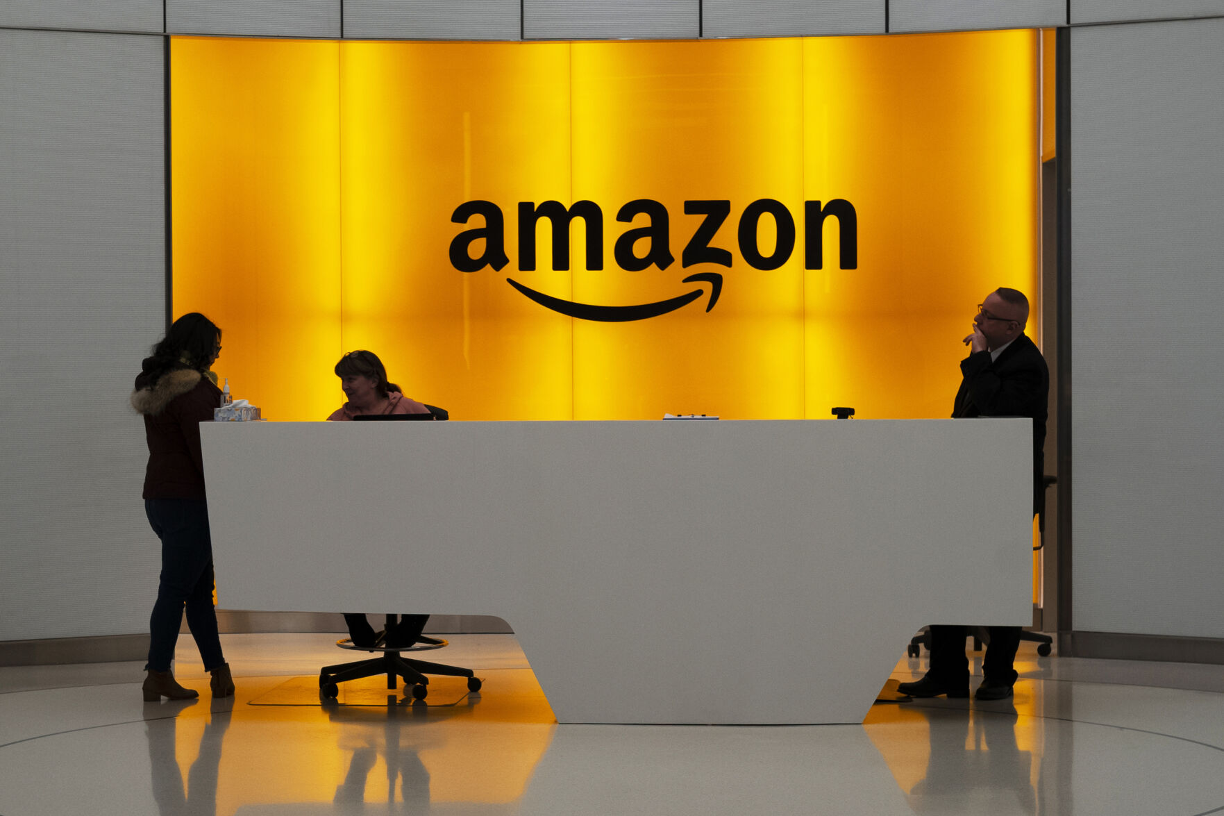 <p>FILE - In this Feb. 14, 2019, file photo people stand in the lobby for Amazon offices in New York. Amazon is kicking off its annual security-focused cloud computing conference on Tuesday amid a slowdown in its profitable cloud business Amazon Web Services, or AWS. (AP Photo/Mark Lennihan, File)</p>   PHOTO CREDIT: Mark Lennihan 