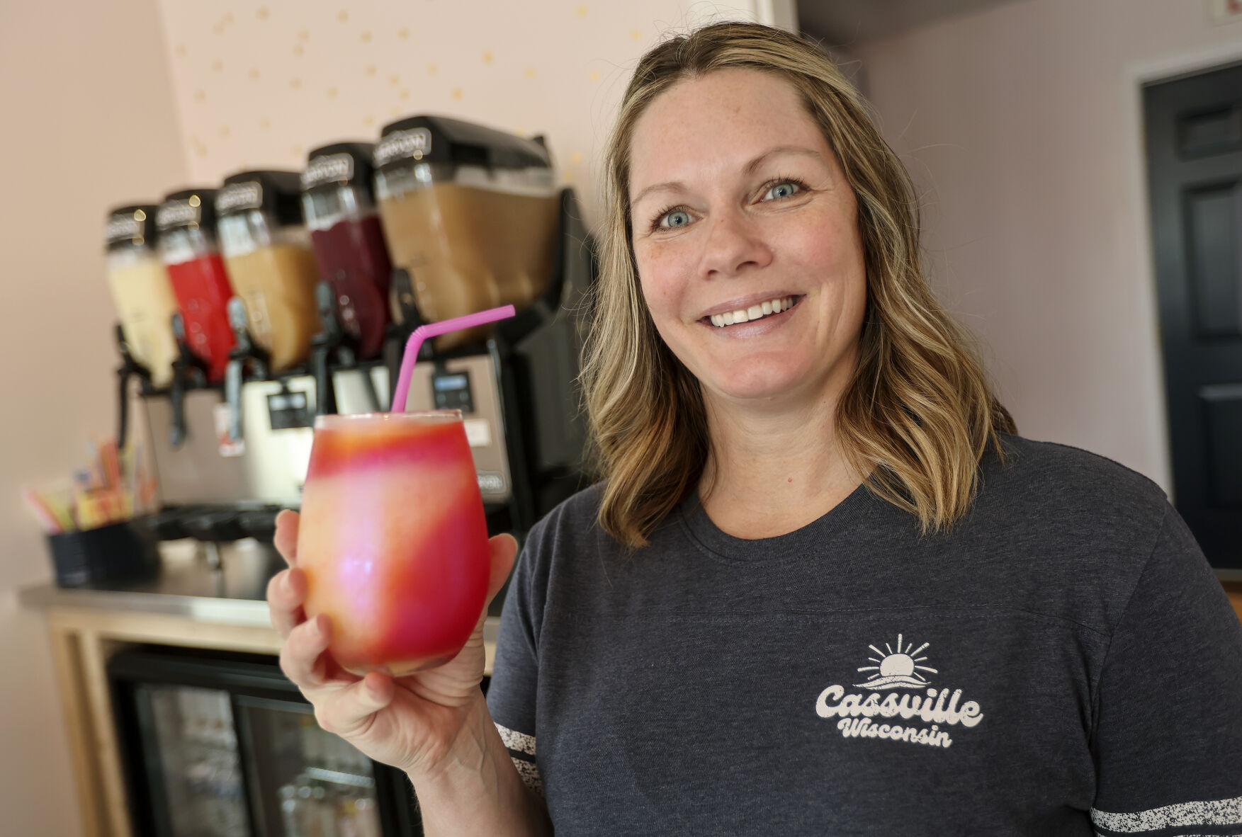 Owner of The Neighborhood Slush Carrie Wunderlin holds one of her wine slush drinks at her business located in Cassville, Wis., on Thursday, June 15, 2023.    PHOTO CREDIT: Dave Kettering