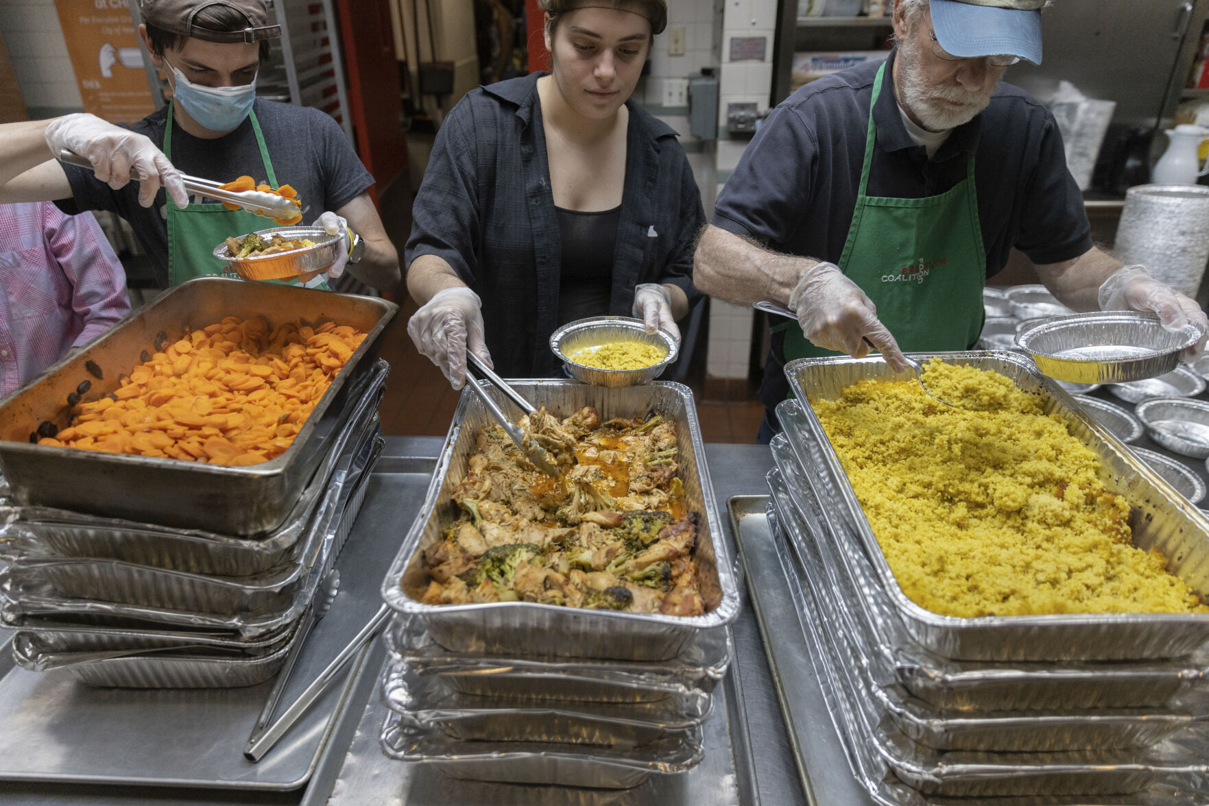 <p>Nicholas Loud, left, Sophie Thurschwell, center, and Peter Woll prepare lunch boxes at Community Help in Park Slope, a soup kitchen and food pantry better known as CHiPS, on Friday, June 16, 2023 in New York. Charitable giving in the United States declined in 2022. The downturn in giving has led to issues at CHiPS, as it has in many charities across the country. (AP Photo/Jeenah Moon)</p>   PHOTO CREDIT: Jeenah Moon
