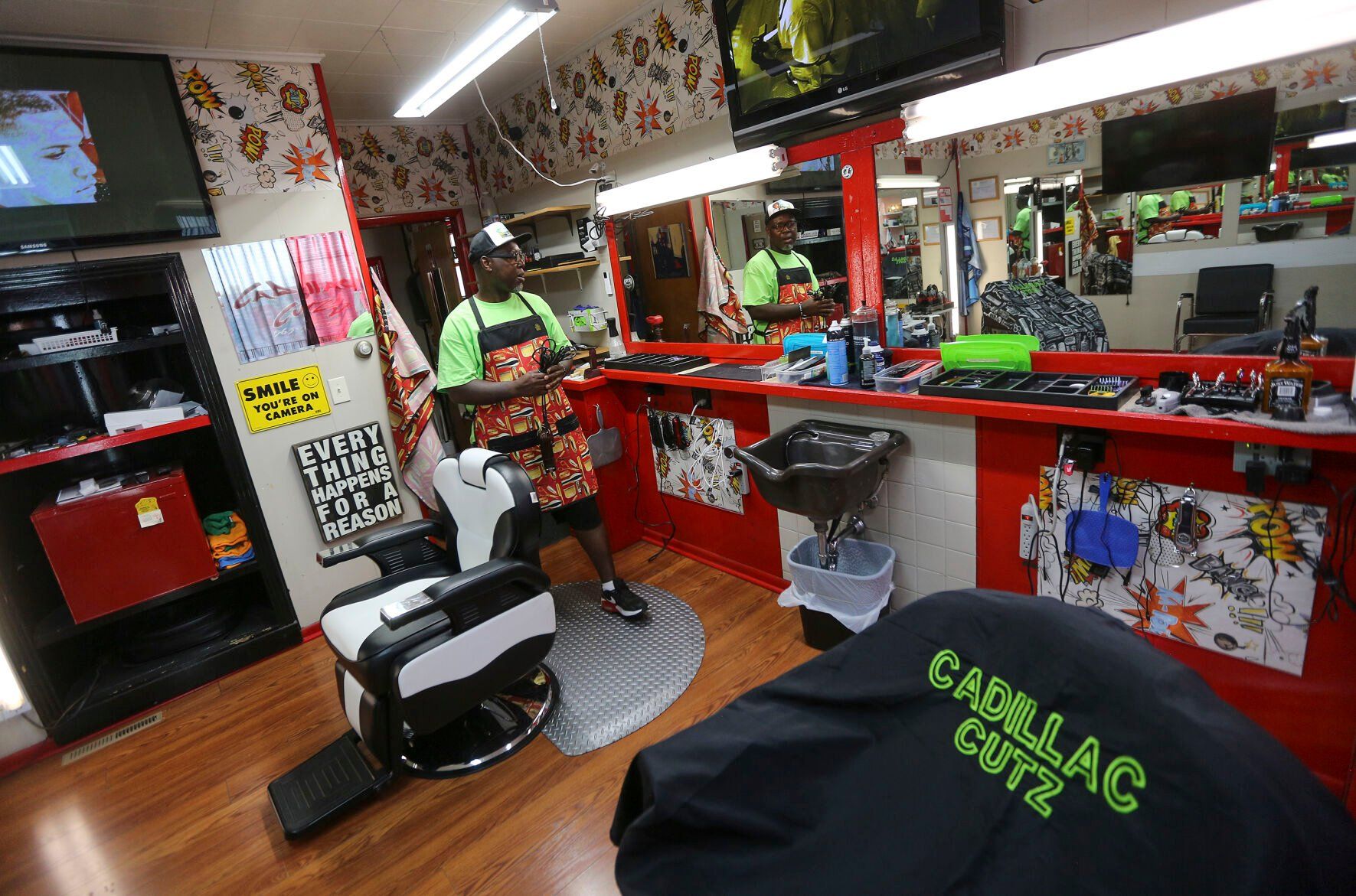 Makiah Cooper, owner of Cadillac Cutz on Elm Street in Dubuque, prepares the shop for a customer visit.    PHOTO CREDIT: Dave Kettering
Telegraph Herald