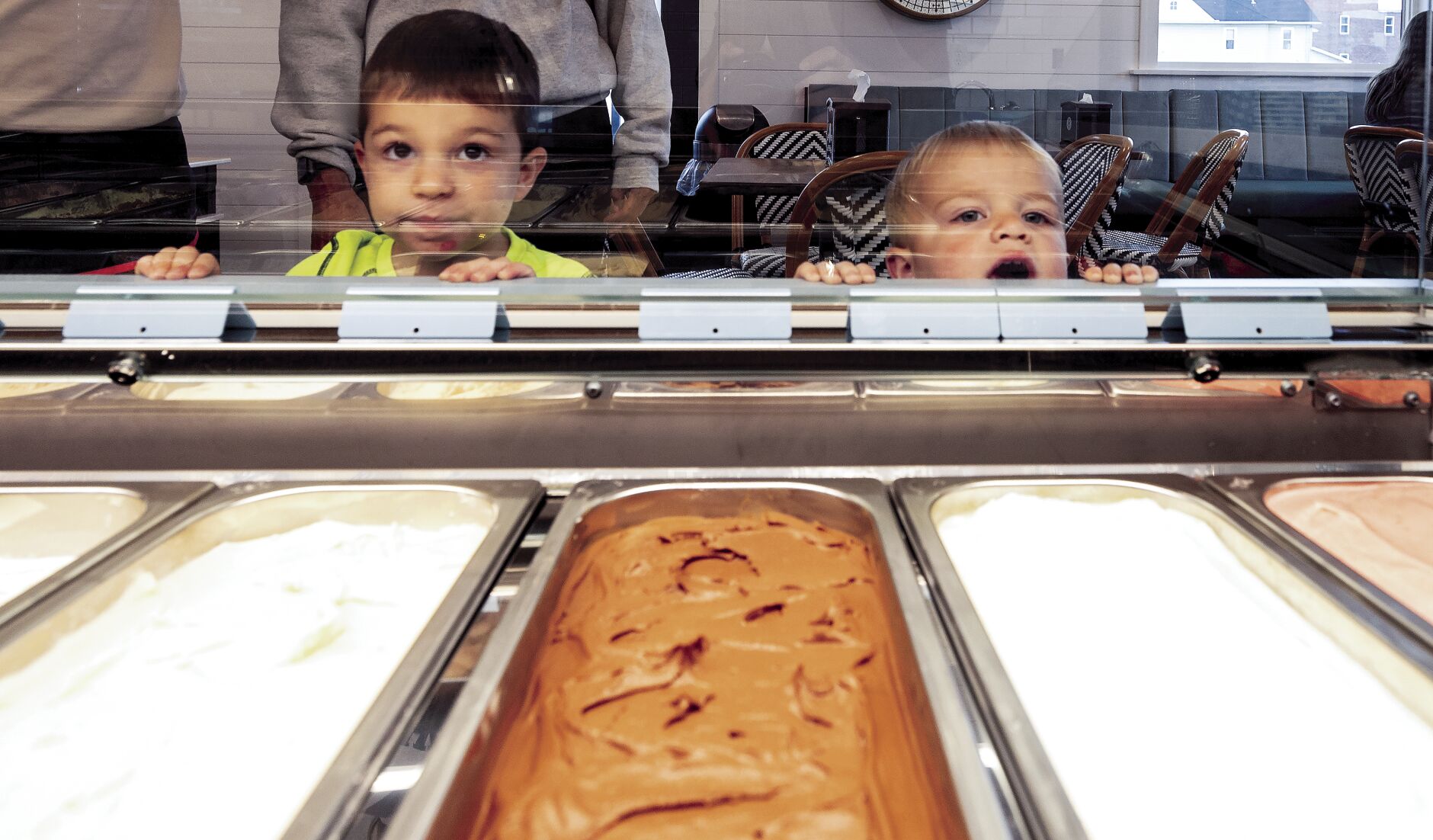 Eli (left) and Theo Anstoetter look over the selection at Millwork Creamery in Dyersville, Iowa, on Friday.    PHOTO CREDIT: Stephen Gassman