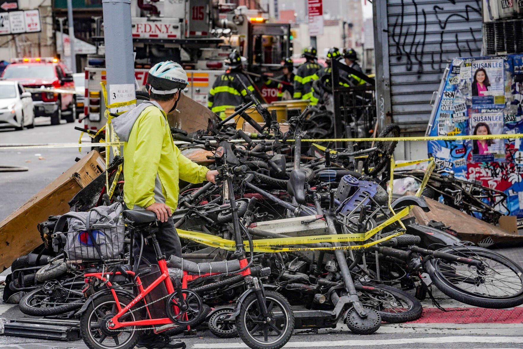 <p>FILE - A biker stops to look at a pile of e-bikes in the aftermath of a fire in Chinatown, which authorities say started at an e-bike shop and spread to upper-floor apartments, Tuesday June 20, 2023, in New York. Federal officials are looking into cracking down on defective lithium-ion batteries that power hoverboards, scooters and motorized bicycles because of a rash of deadly fires caused by exploding batteries. The effort comes as New York City implements new laws meant to reduce the number of fires, injuries and deaths in a city where e-bikes have become ubiquitous. (AP Photo/Bebeto Matthews, File)</p>   PHOTO CREDIT: Bebeto Matthews 