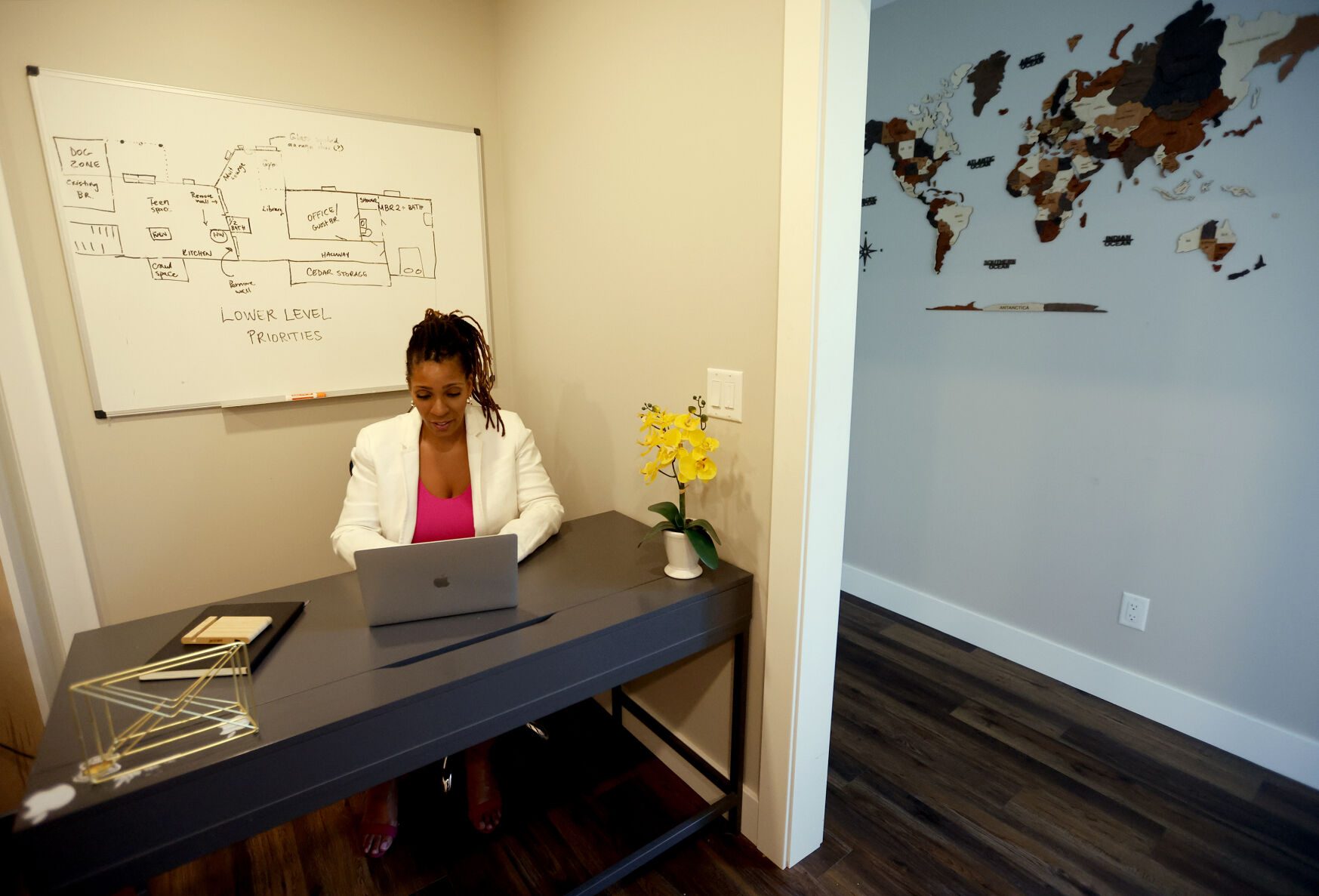 Yindra Dixon, managing director at Nia Neighborhoods Opportunity Zone Fund, works at her home in Dubuque.    PHOTO CREDIT: Jessica Reilly