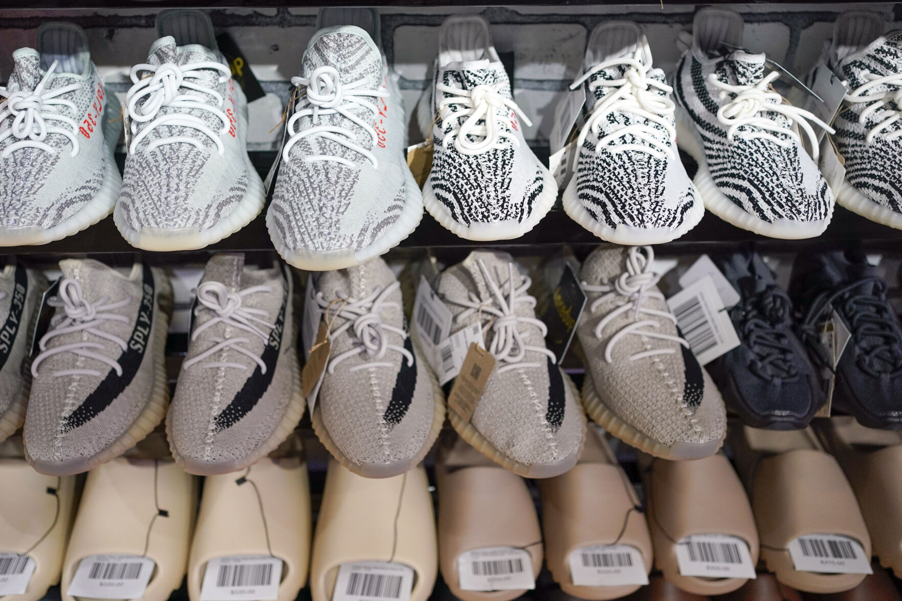 <p>FILE - Yeezy shoes made by Adidas are displayed at Laced Up, a sneaker resale store, in Paramus, N.J., on Oct. 25, 2022. Adidas is releasing a second batch of high-end Yeezy sneakers after cutting ties with rapper Ye, formerly known as Kanye West, as the shoemaker seeks to unload the unsold shoes while donating to groups fighting antisemitism. The online sale, to start Wednesday Aug. 2, 2023 through the Confirmed app, Adidas app and adidas.com, follows an earlier batch of sales in May. (AP Photo/Seth Wenig, File)</p>   PHOTO CREDIT: Seth Wenig 