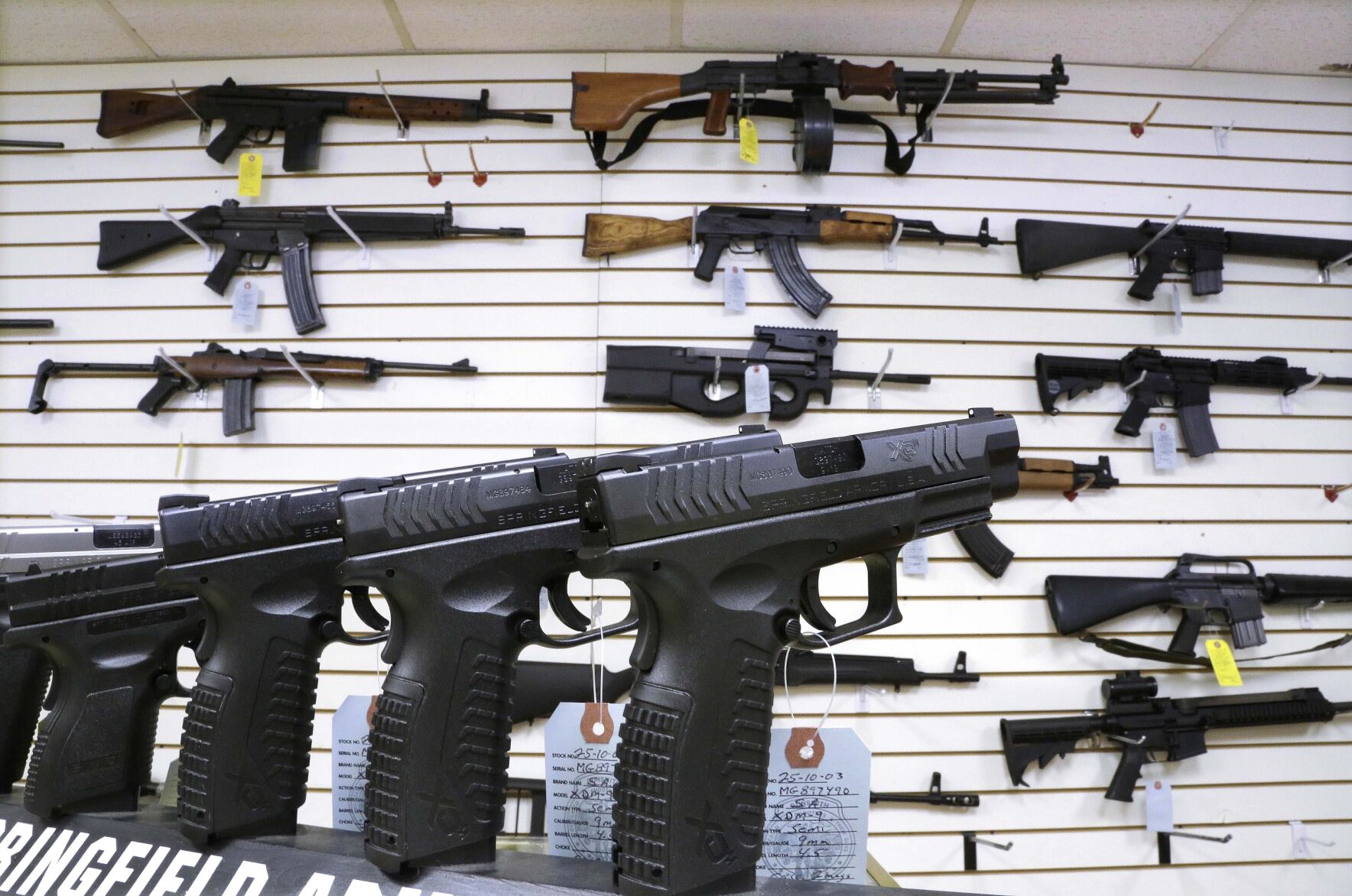 <p>FILE - Semi-automatic guns are displayed for sale at Capitol City Arms Supply, Jan. 16, 2013, in Springfield, Ill. Illinois will soon outlaw advertising for firearms that officials determine produces a public safety threat or appeals to children, militants or others who might later use them illegally, as the state continues its quest to curb mass shootings. (AP Photo/Seth Perlman, File)</p>   PHOTO CREDIT: Seth Perlman 