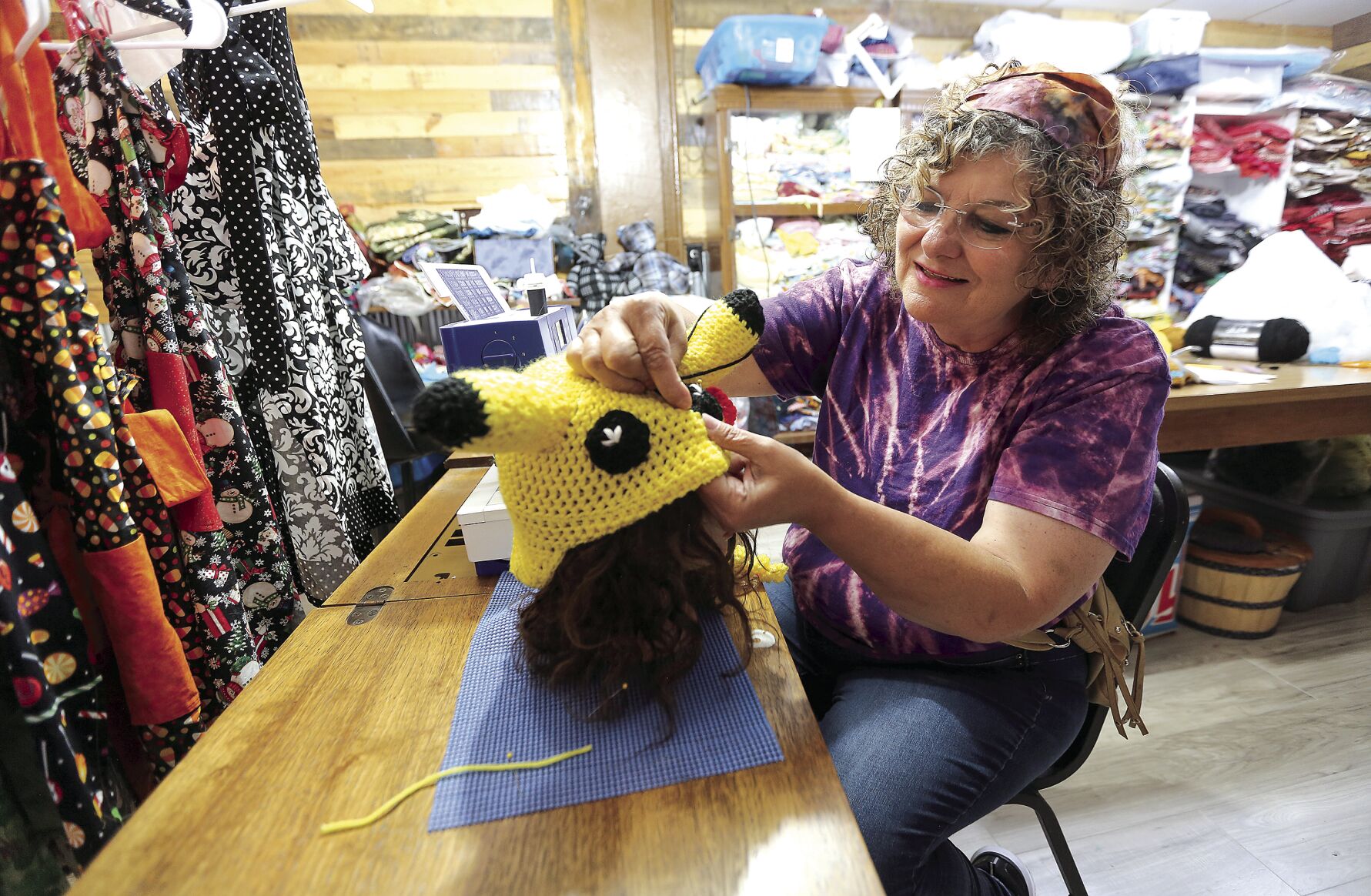 Annie Heinze, owner of Annie’s Heirlooms, works on making a hat in her store on Elm Street in Dubuque.    PHOTO CREDIT: Dave Kettering
