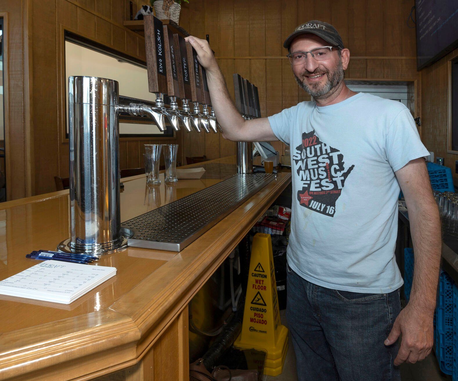 Owner John Patakos stands at the taps of UpDraft Brewery in Platteville, Wis., on Tuesday, Aug., 15, 2023.    PHOTO CREDIT: Stephen Gassman