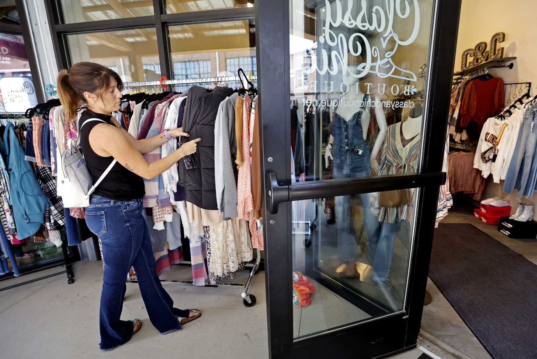 Abbie Bartels, of Bellevue, Iowa, browses clothing at Classy & Chic Boutique in Dubuque on Friday, Aug. 18, 2023.    PHOTO CREDIT: JESSICA REILLY