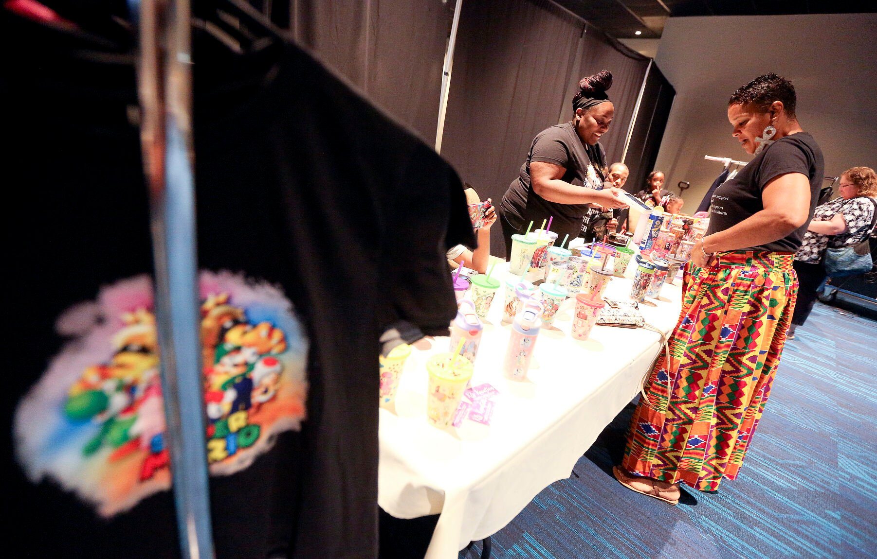 Tika Sykes (left), owner of KLS Kreation, talks with fellow businesswoman Jackie Hunter during the third annual Black Business Expo held at the Q Casino.    PHOTO CREDIT: Dave Kettering