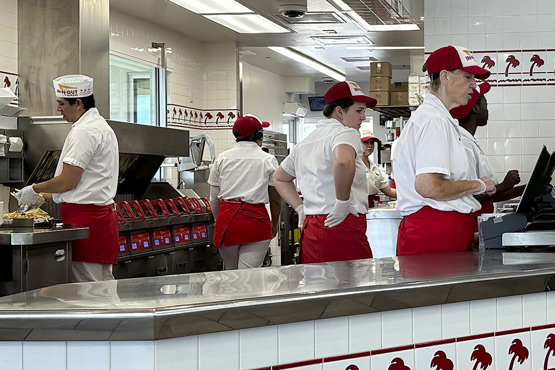 <p>Workers prepare food and take orders an In-N-Out burger restaurant Tuesday, Aug. 8, 2023, in Thornton, Colo. On Friday, the U.S. government issues the August jobs report. (AP Photo/David Zalubowski)</p>   PHOTO CREDIT: David Zalubowski - staff, ASSOCIATED PRESS