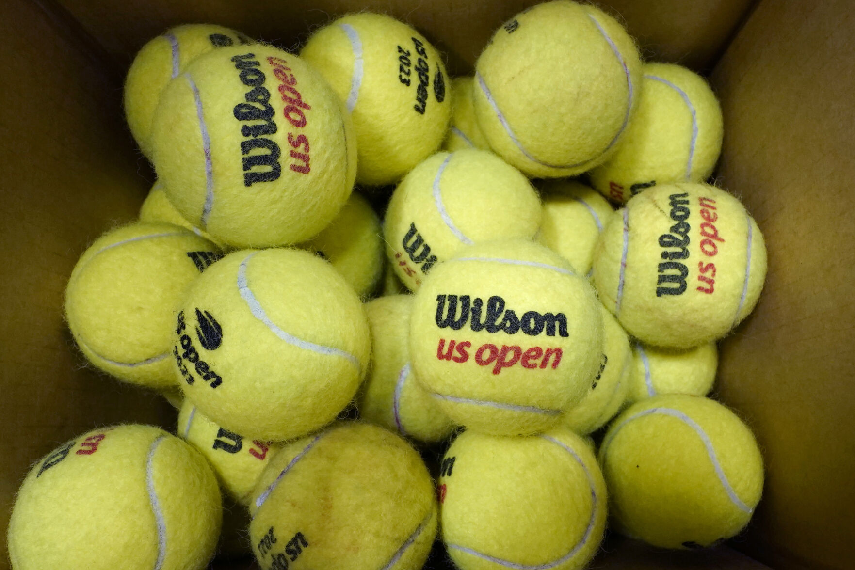 <p>A box of game-used tennis balls rest in a shipping box during the U.S. Open tennis championships, Monday, Sept. 4, 2023, in New York. Because tennis balls are extremely hard to recycle and the industry has yet to develop a ball to make that easier, nearly all of the 330 million balls made worldwide each year eventually get chucked in the garbage, with most ending up in landfills. (AP Photo/Eduardo Munoz Alvarez)</p>   PHOTO CREDIT: Eduardo Munoz Alvarez 