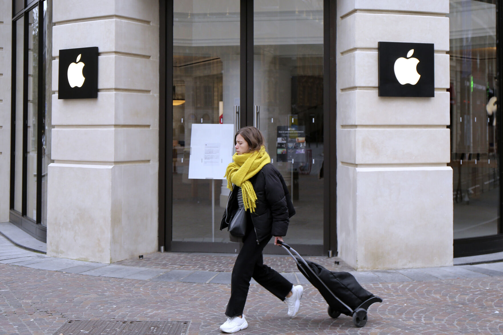 <p>FILE - A woman walks past a closed Apple Store in Lille, northern France, Monday, March 16, 2020. A French watchdog ordered Apple to withdraw the iPhone 12 from the market because it is emitting too high levels of electromagnetic radiation. The National Frequencies Agency (ANFR), the body monitoring public exposure to radiations, called on Apple to "implement all available means to rapidly fix this malfunction," in a statement released on Tuesday Sept.12, 2023. (AP Photo/Michel Spingler, File)</p>   PHOTO CREDIT: Michel Spingler - stringer, ASSOCIATED PRESS