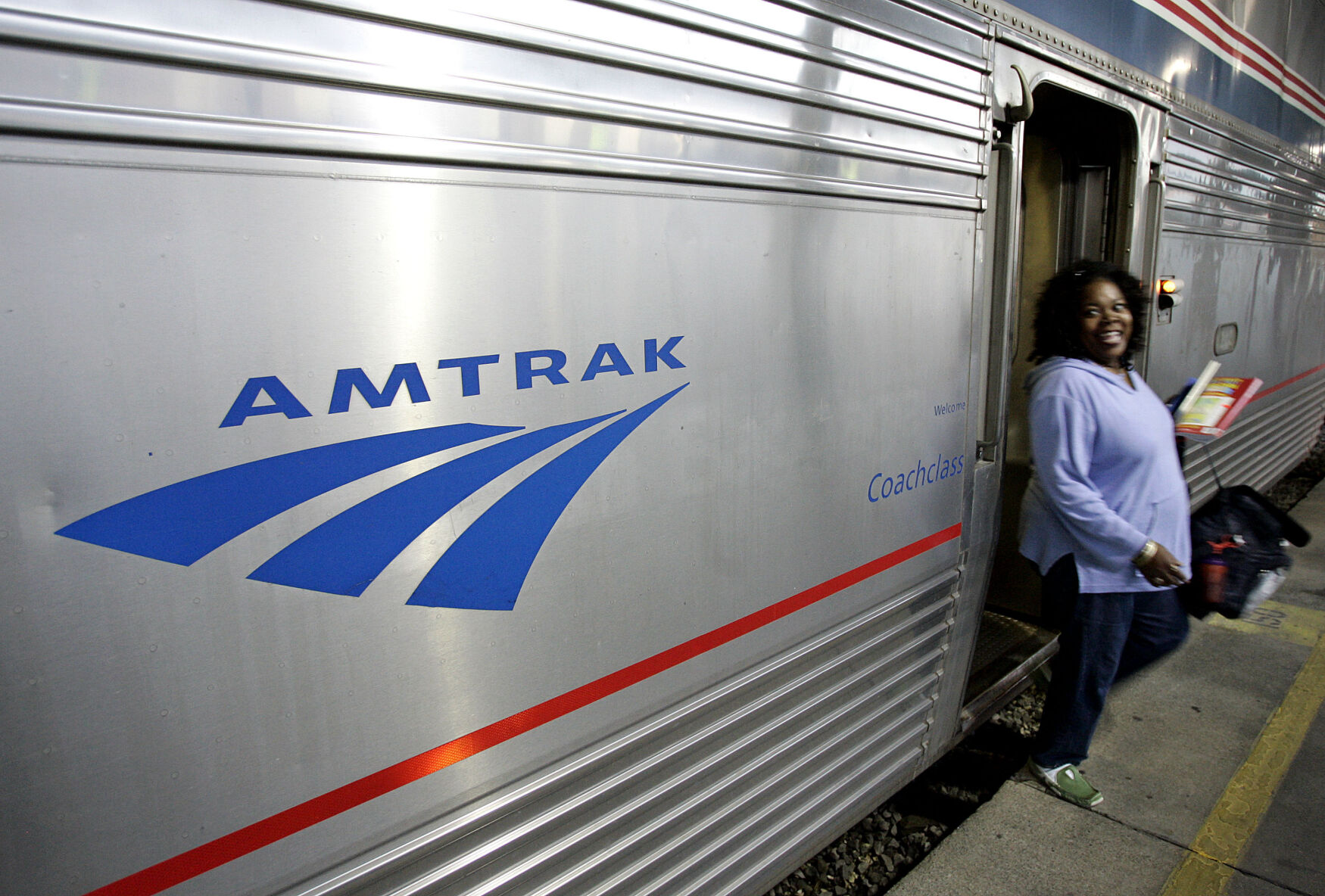 FILE - A passenger disembarks from Amtrak