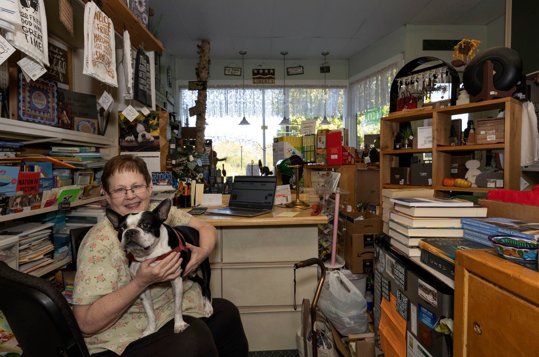 Sheila Hargrave, owner of The BookWorm, sits with dog Brodie in the Bellevue, Iowa, store on Friday.    PHOTO CREDIT: Gassman