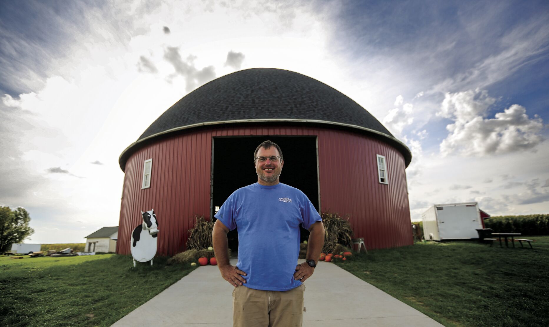 Kyle Vesperman stands in front of the 1913 round barn that now is part of Vesperman Farms’ yearly fall offerings.    PHOTO CREDIT: Dave Kettering