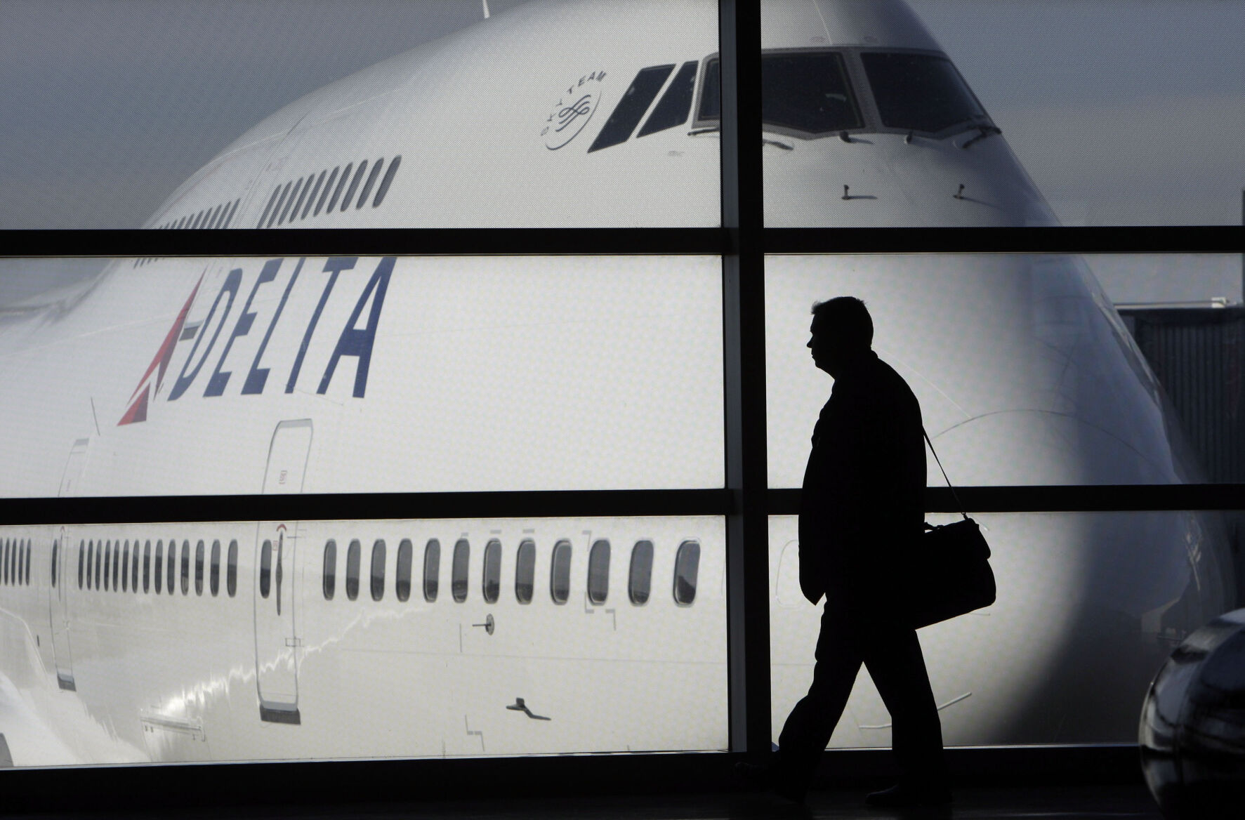 <p>FILE - In this file photo made Jan. 21, 2010, a passenger walks past a Delta Airlines 747 aircraft in McNamara Terminal at Detroit Metropolitan Wayne County Airport in Romulus, Mich. Major airlines are suspending flights to Israel after it formally declared war following a massive attack by Hamas. American Airlines, United Airlines and Delta Air Lines suspended service as the U.S. State Department issued travel advisories for the region citing potential for terrorism and civil unrest. Delta said its Tel Aviv flights have been canceled into this week. (AP Photo/Paul Sancya, File)</p>   PHOTO CREDIT: Paul Sancya