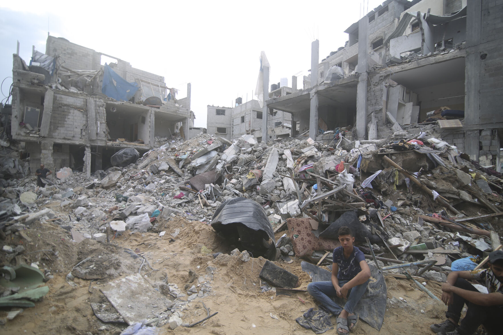 <p>Palestinians isit by the rubble Abu Helal family in Rafah refugee camp, Gaza Strip, Monday, Oct. 9, 2023. The strike killed dozens of people.(AP Photo/Hatem Ali)</p>   PHOTO CREDIT: Hatem Ali - stringer, ASSOCIATED PRESS