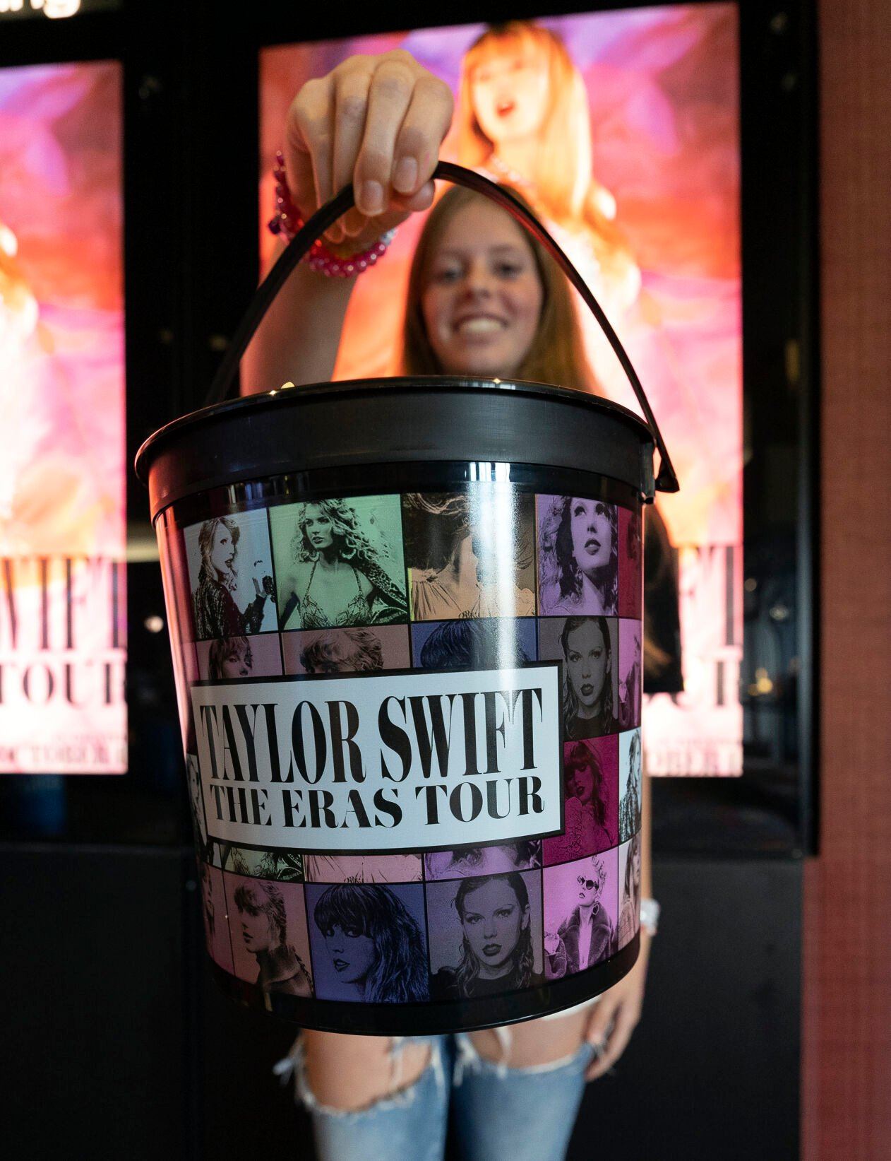 Ellie Miller, 14, holds up her popcorn bucket at the “Taylor Swift: The Eras Tour” concert film at Phoenix Theatres in Dubuque on Saturday, Oct. 14, 2023.    PHOTO CREDIT: Stephen Gassman
