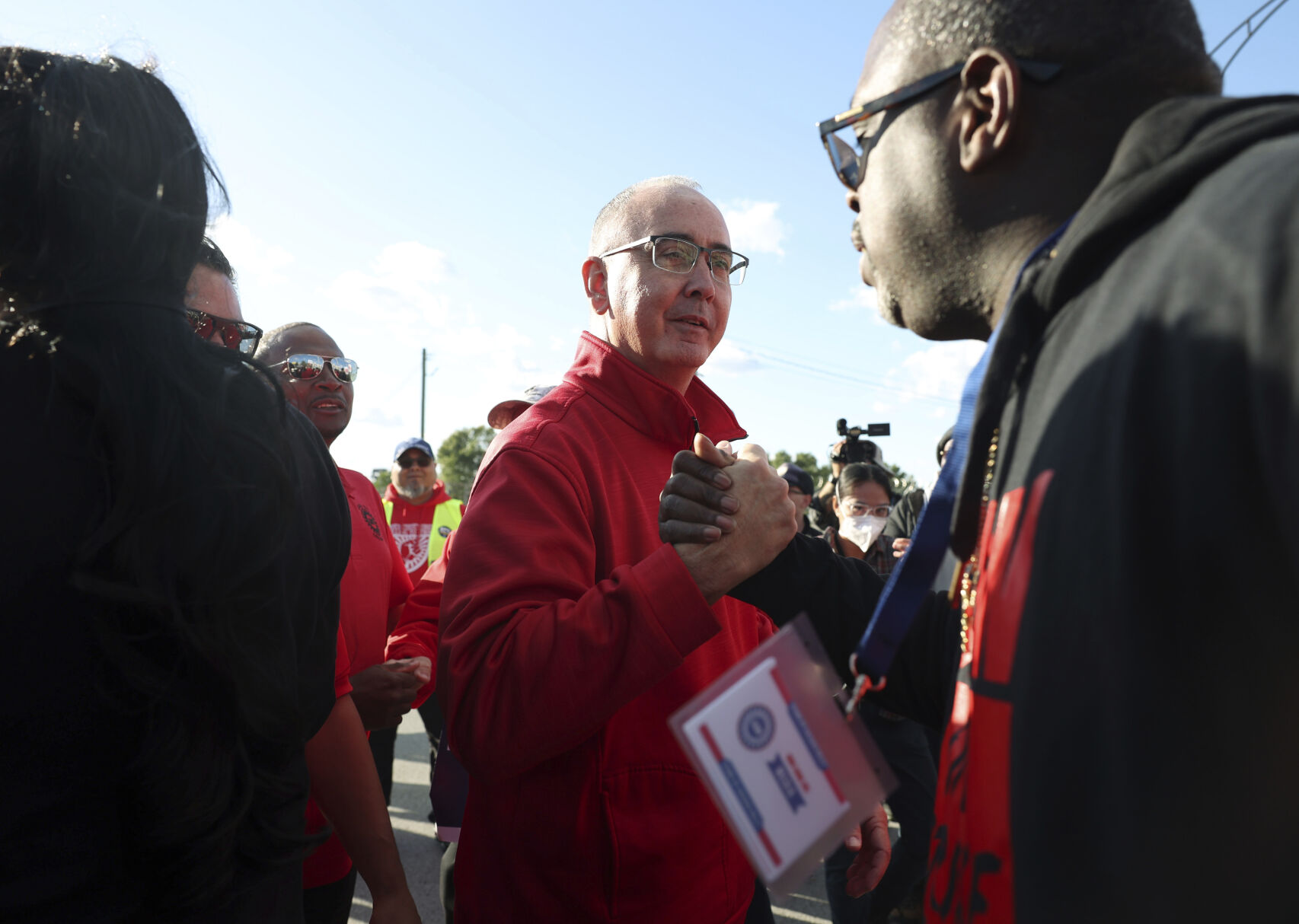 <p>File - United Auto Workers President Shawn Fain, center, visits striking UAW Local 551 workers outside a Ford assembly center on South Burley Avenue on Oct. 7, 2023, in Chicago. Throughout its 5-week-old strikes against Detroit’s automakers, the United Auto Workers union has cast an emphatically combative stance, reflecting the style of Fain, its pugnacious leader. (John J. Kim /Chicago Tribune via AP, File)</p>   PHOTO CREDIT: John J. Kim 