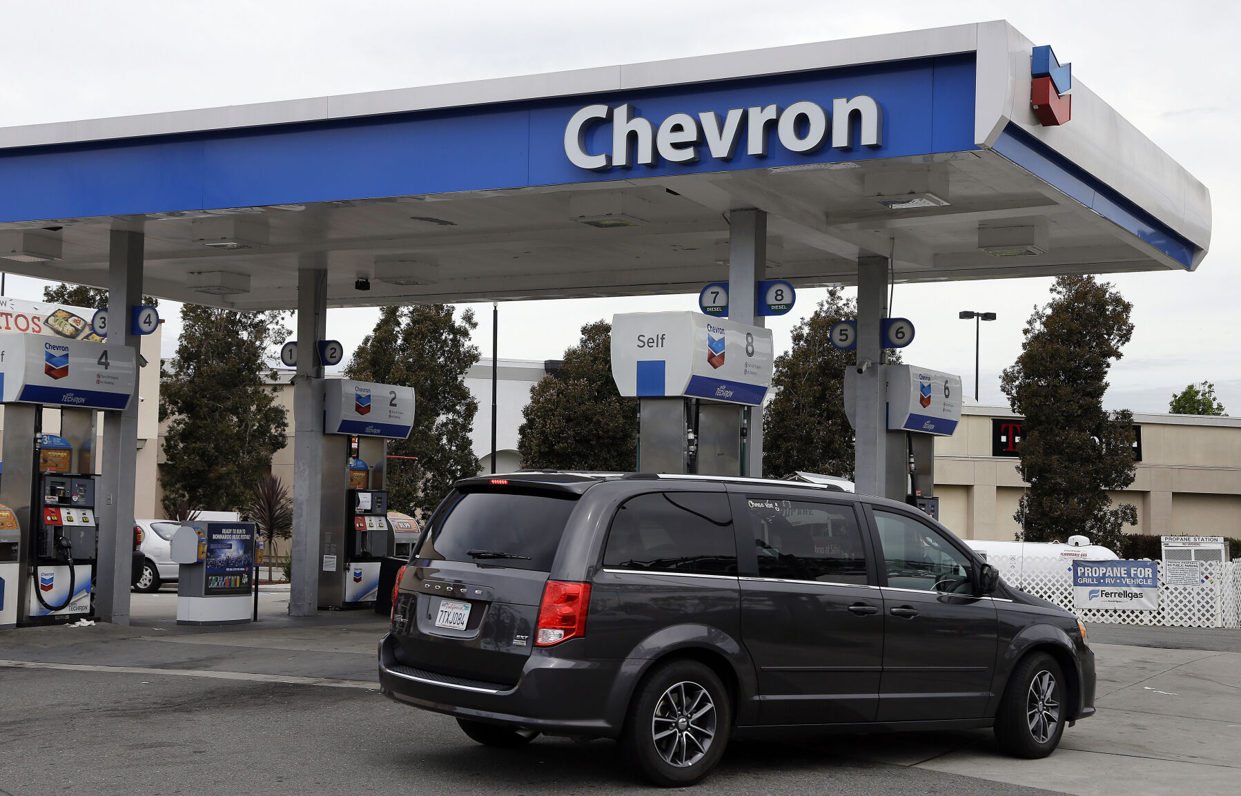 <p>FILE - A motorist drives near the pumps at a Chevron gas station in Oakland, Calif., on April 25, 2017. Chevron is buying Hess Corp. for $53 billion as the biggest U.S. oil companies use a recent windfall in profits to buy up smaller competitors, Chevron said in a press release Monday, Oct. 23, 2023. (AP Photo/Ben Margot, File)</p>   PHOTO CREDIT: Ben Margot 