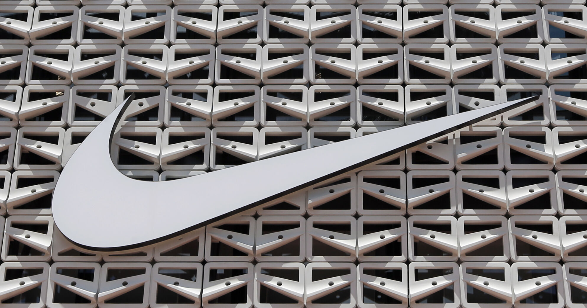 <p>File - The Nike logo is shown on a store in Miami Beach, Fla. on Aug. 8, 2017. An agreement to weed out global tax havens and force multinational corporations, among them Apple and Nike, to pay a minimum tax has been weakened by loopholes and will raise only a fraction of the revenue that was envisioned, a tax watchdog backed by the European Union has warned. (AP Photo/Alan Diaz, File)</p>   PHOTO CREDIT: Alan Diaz 