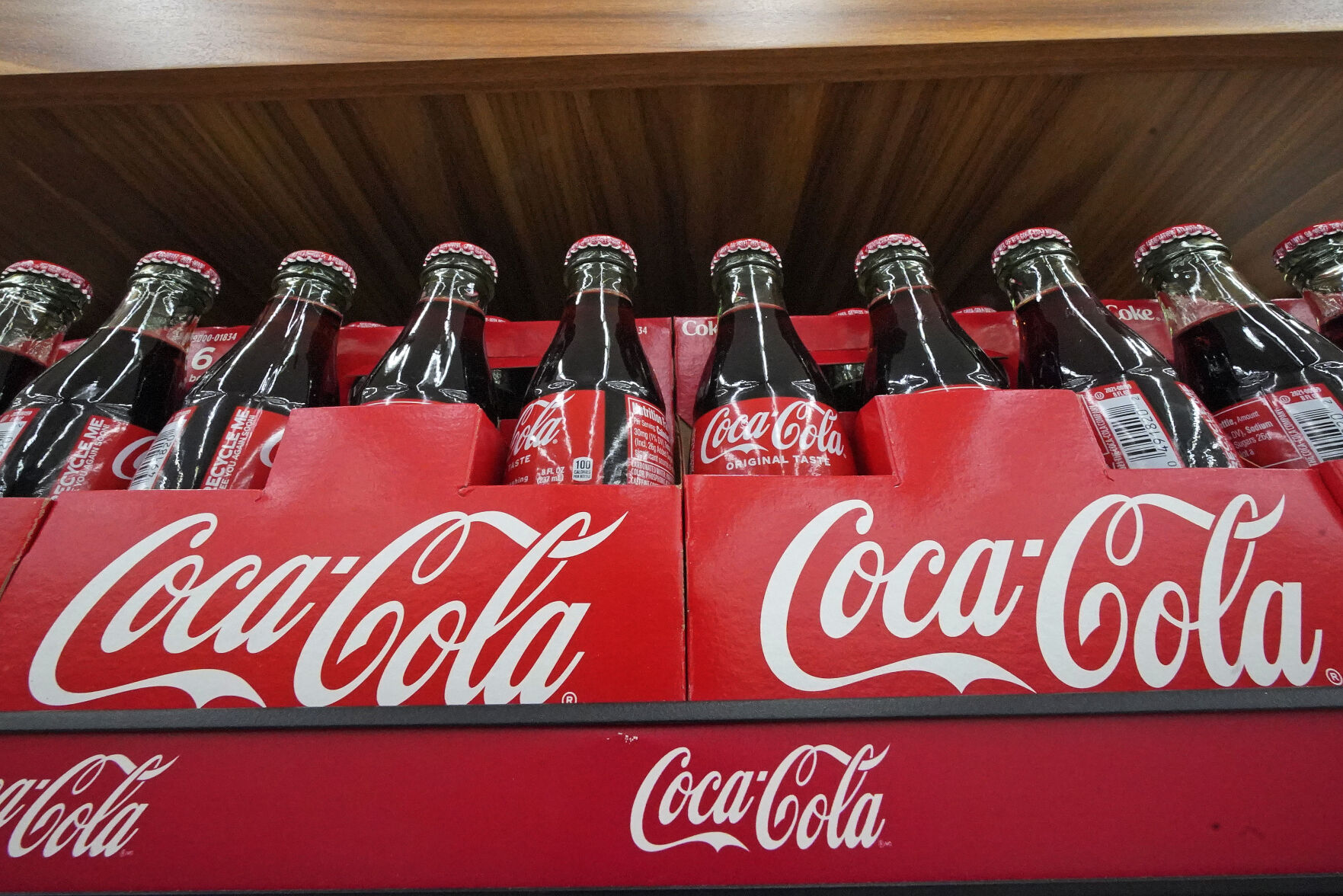 <p>Bottles of Coca-Cola are on display at a grocery market in Uniontown, Pa, on Sunday, April 24, 2022. Coca-Cola reports earnings on Tuesday, Oct. 24, 2023. (AP Photo/Gene J. Puskar)</p>   PHOTO CREDIT: Gene J. Puskar 