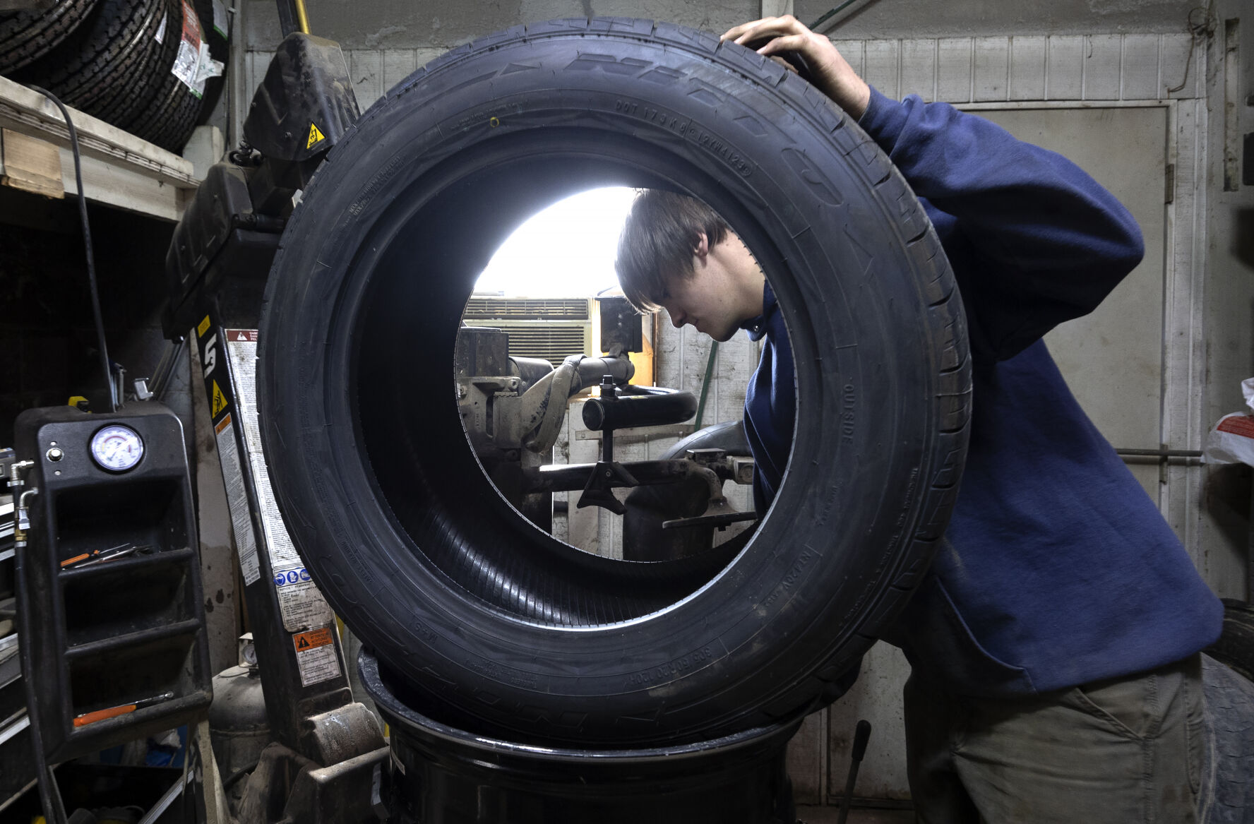 Owner Jack Kremer works on a tire at Kremer Tire & Auto in La Motte, Iowa, on Thursday, Nov. 2, 2023.    PHOTO CREDIT: Stephen Gassman