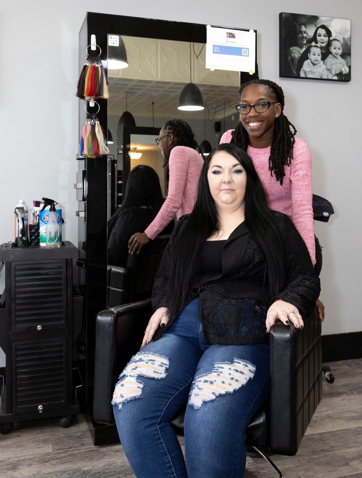 Owner Margaret Detwiler (seated) and esthetician Dwanna Sykes work at A Touch of Amy Hair & More in Dubuque on Friday.    PHOTO CREDIT: Stephen Gassman