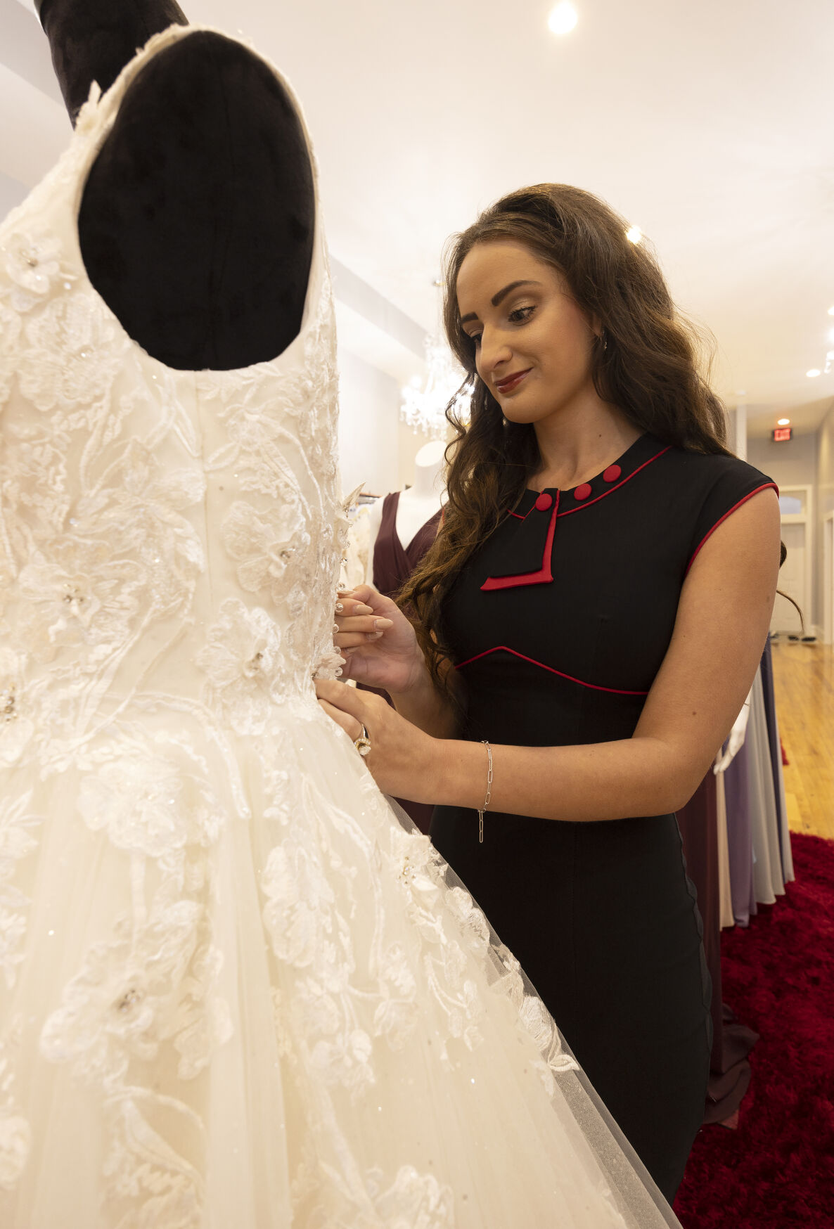 Soat zips up a wedding dress on a mannequin at All in One Bridal.    PHOTO CREDIT: Stephen Gassman
Telegraph Herald