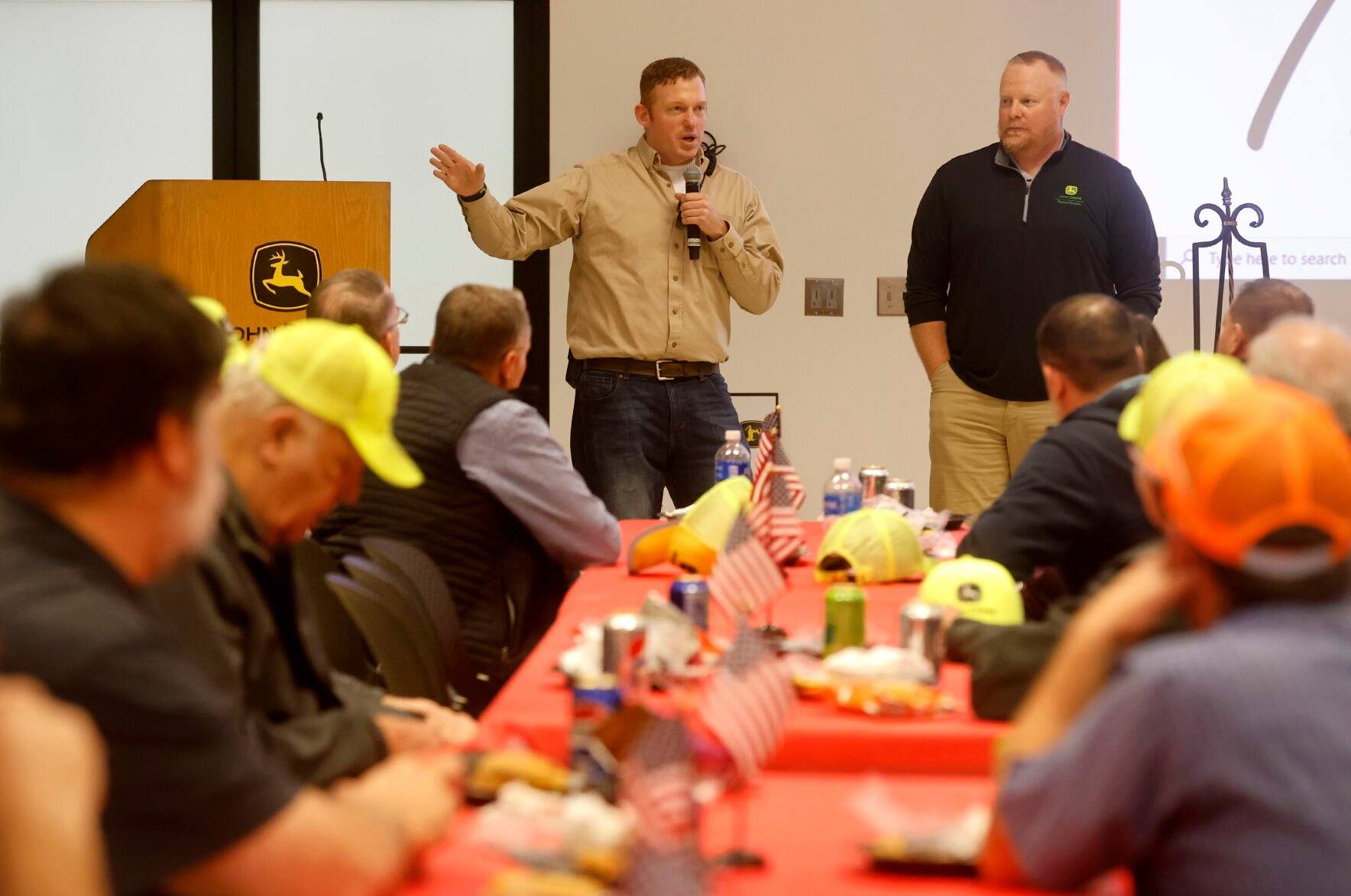 Alec Zwanziger (left) and Dan Kerkhoff, both with John Deere Dubuque Works, speak during a Veterans Day luncheon recognizing employee veterans at the facility in Dubuque on Thursday, Nov. 9, 2023.    PHOTO CREDIT: JESSICA REILLY