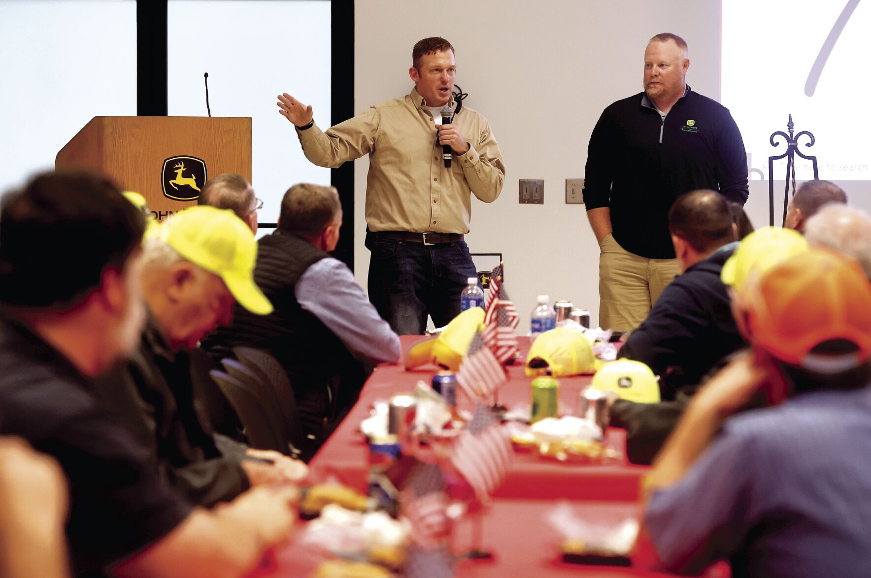 Alec Zwanziger (left) and Dan Kerkhoff, both with John Deere Dubuque Works, speak during a Veterans Day luncheon recognizing employees who served in the military at the facility in Dubuque on Thursday.    PHOTO CREDIT: JESSICA REILLY