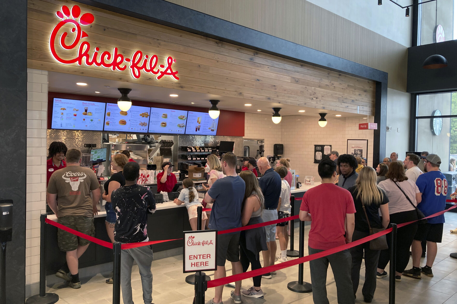 <p>File - People line up to order fast food from a Chick-fil-A restaurant at the Iroquois Travel Plaza rest stop on the New York State Thruway in Little Falls, New York, on June 30, 2023. On Tuesday, the Labor Department issues its report on inflation at the consumer level in October. (AP Photo/Ted Shaffrey, File)</p>   PHOTO CREDIT: Ted Shaffrey - staff, ASSOCIATED PRESS