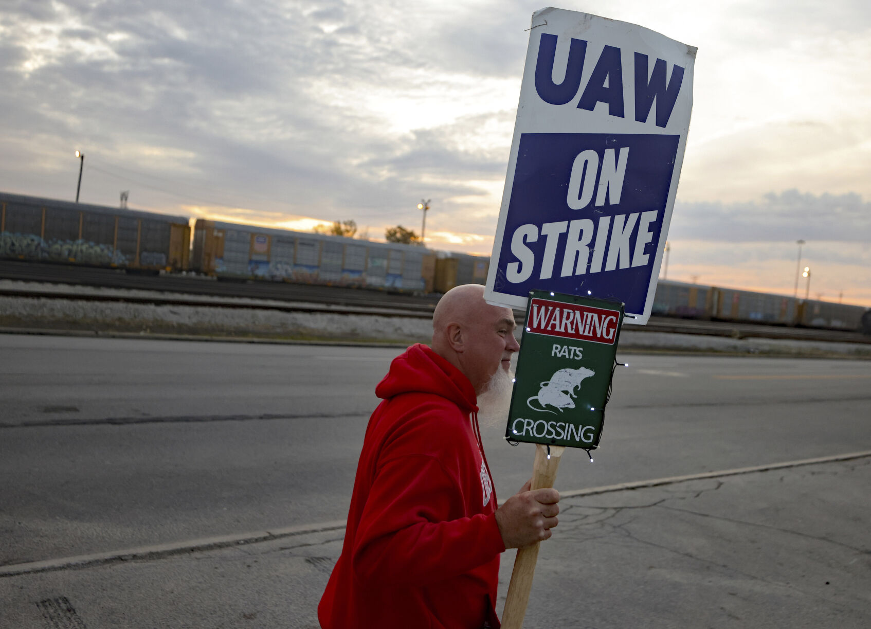 <p>File - Dan Back, a United Auto Workers Local 12 member, pickets during the ongoing UAW strike at the Stellantis Toledo Assembly Complex on Thursday, Oct. 26, 2023, in Toledo, Ohio. Members of the United Auto Workers union moved closer to approving a contract agreement with Stellantis on Friday, Nov. 17, as two large factories in Detroit voted overwhelmingly for the deal. (Kurt Steiss/The Blade via AP, File)</p>   PHOTO CREDIT: Kurt Steiss - member, ASSOCIATED PRESS