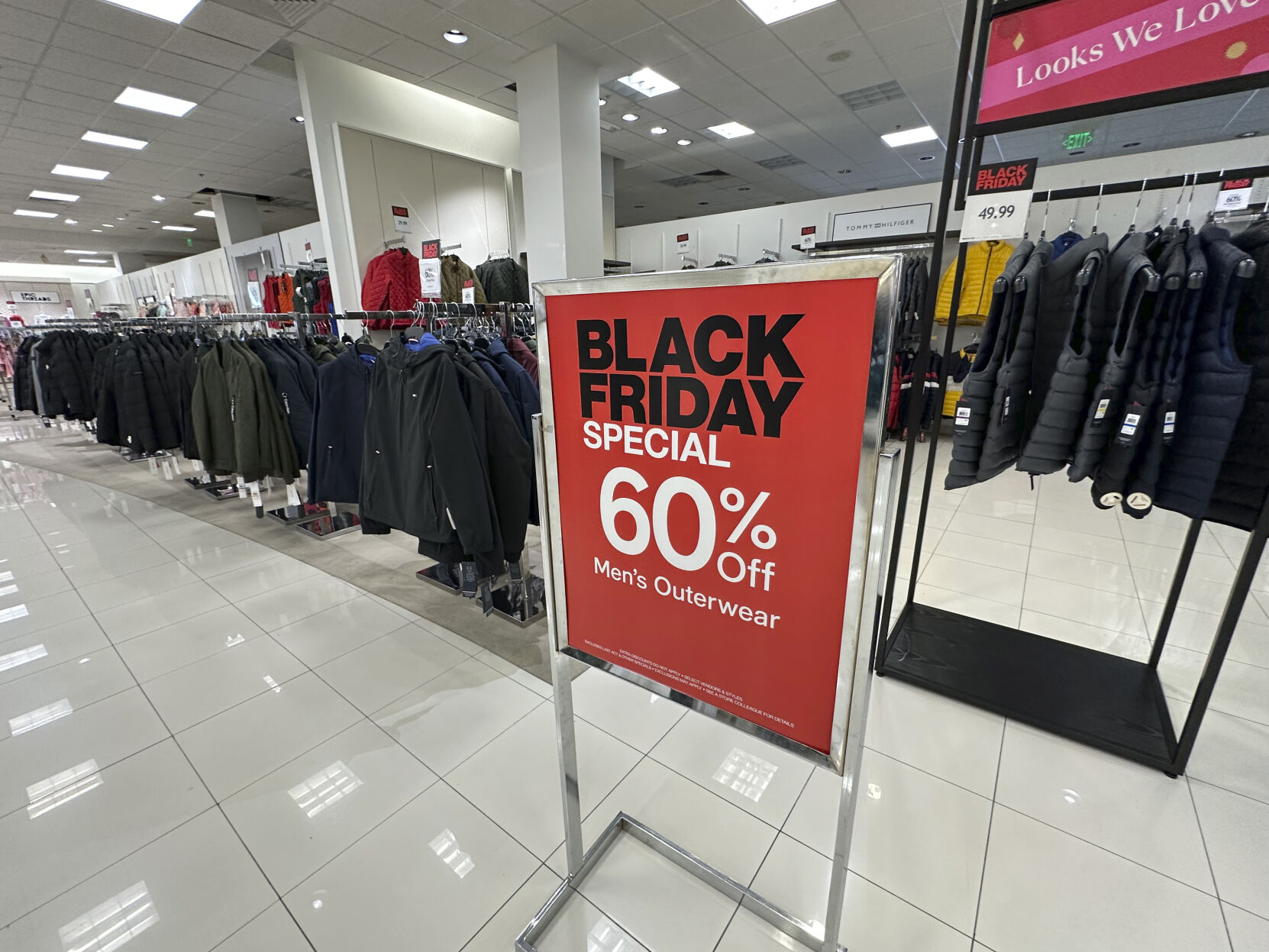 A sign notes Black Friday discount available on racks of men