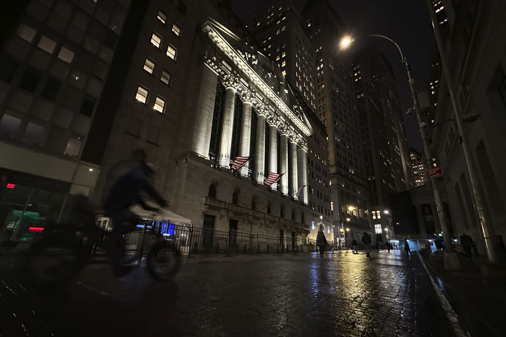 A bike approaches the New York Stock Exchange on Tuesday, Nov. 21, 2023 in New York. World shares were mixed on Wednesday in cautious trading after Wall Street