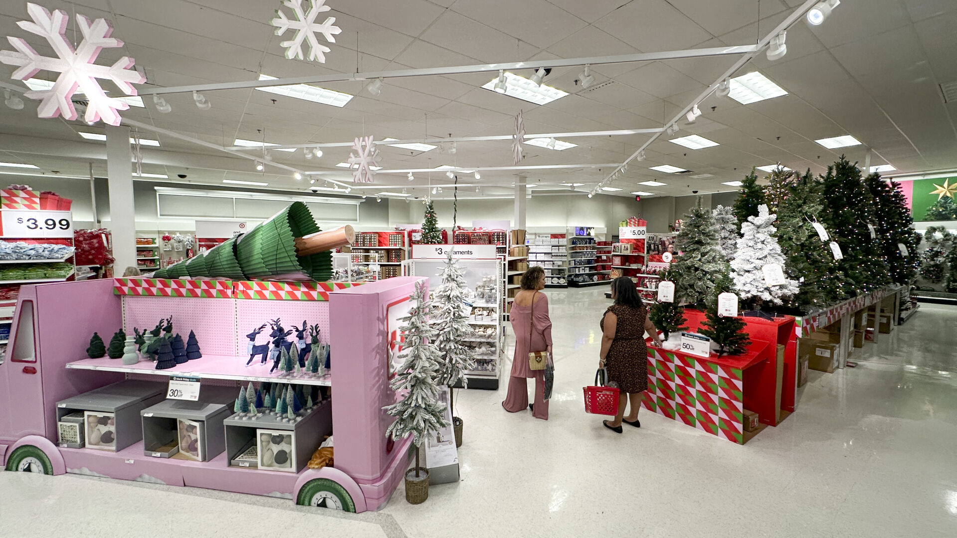 <p>Shoppers look over holiday merchandise on display at a Target store Wednesday, Nov. 15, 2023, in Orlando, Fla. Retailers are kicking off the unofficial start of the holiday shopping season on Friday with a bevy of discounts and other enticements. (AP Photo/John Raoux)</p>   PHOTO CREDIT: John Raoux - staff, ASSOCIATED PRESS