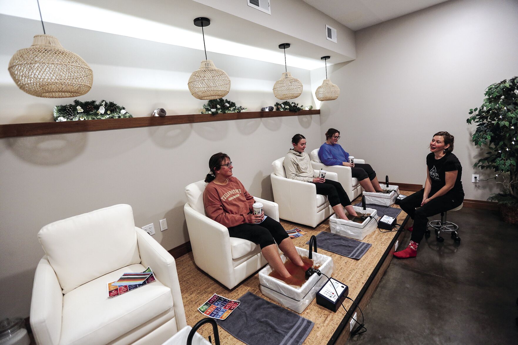 People enjoy a foot detox at The Health Spa by Vive on Friday.    PHOTO CREDIT: Dave Kettering