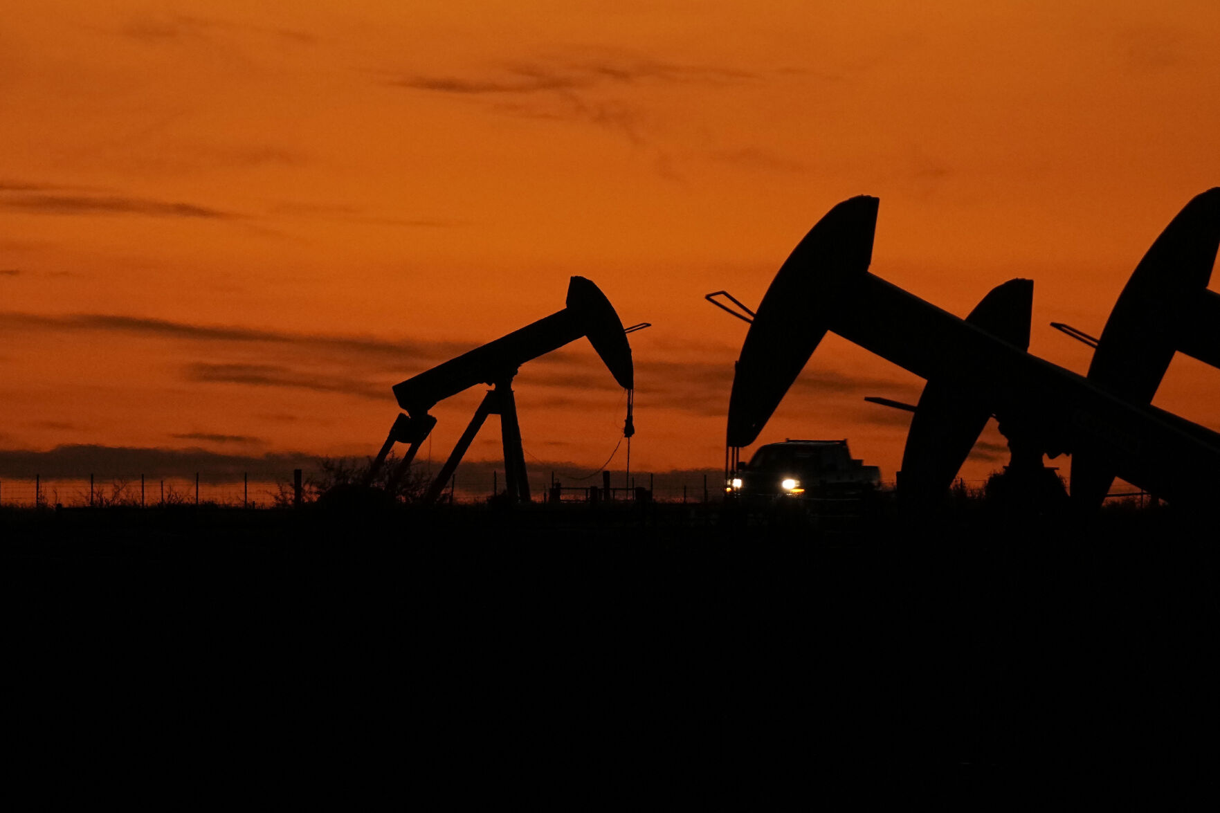 <p>File - A truck passes oil pump jacks at dusk near Karnes City, Texas, Wednesday, Nov. 1, 2023. On Wednesday, the Commerce Department issues its second of three estimates of how the U.S. economy performed in the third quarter of 2023. (AP Photo/Eric Gay, File)</p>   PHOTO CREDIT: Eric Gay
