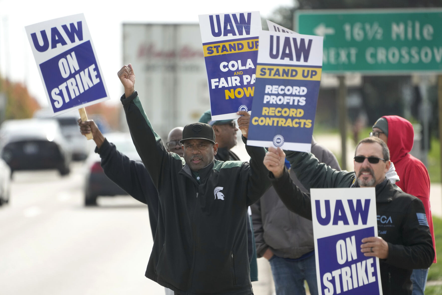 <p>FILE - United Auto Workers members walk the picket line during a strike at the Stellantis Sterling Heights Assembly Plant, in Sterling Heights, Mich., Monday, Oct. 23, 2023. A six-week United Auto Workers strike at Ford cut sales by about 100,000 vehicles and cost the company $1.7 billion in lost profits this year, Ford said Thursday, Nov. 30, 2023. (AP Photo/Paul Sancya, File)</p>   PHOTO CREDIT: Paul Sancya 