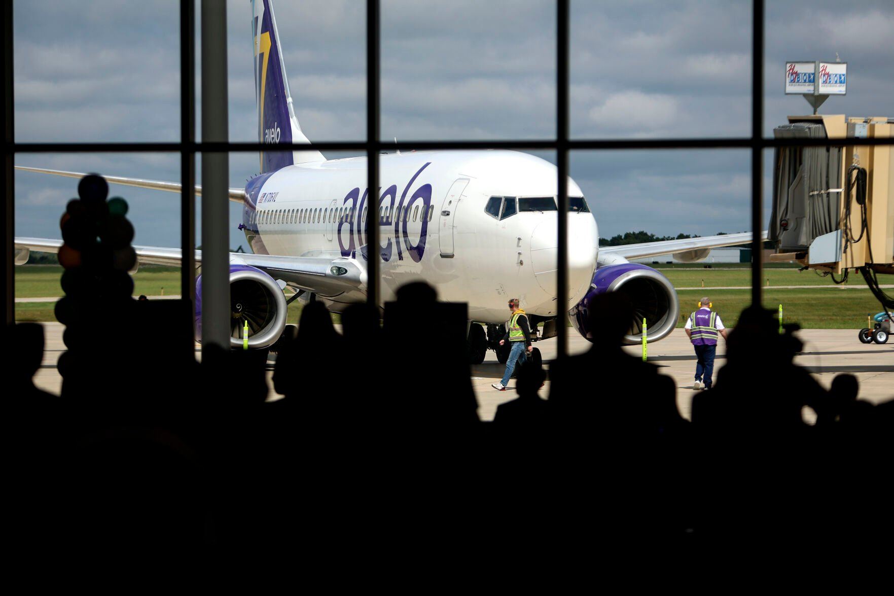 Crews direct an Avelo aircraft to a Dubuque Regional Airport terminal during a ribbon cutting for the airline’s first flight to Las Vegas on Wednesday, Sept. 13, 2023. The airline in November announced it would cease the Las Vegas flights — an announcement that officials say will not deter their goal of finding full-time air service for Dubuque.    PHOTO CREDIT: Dave Kettering
Telegraph Herald